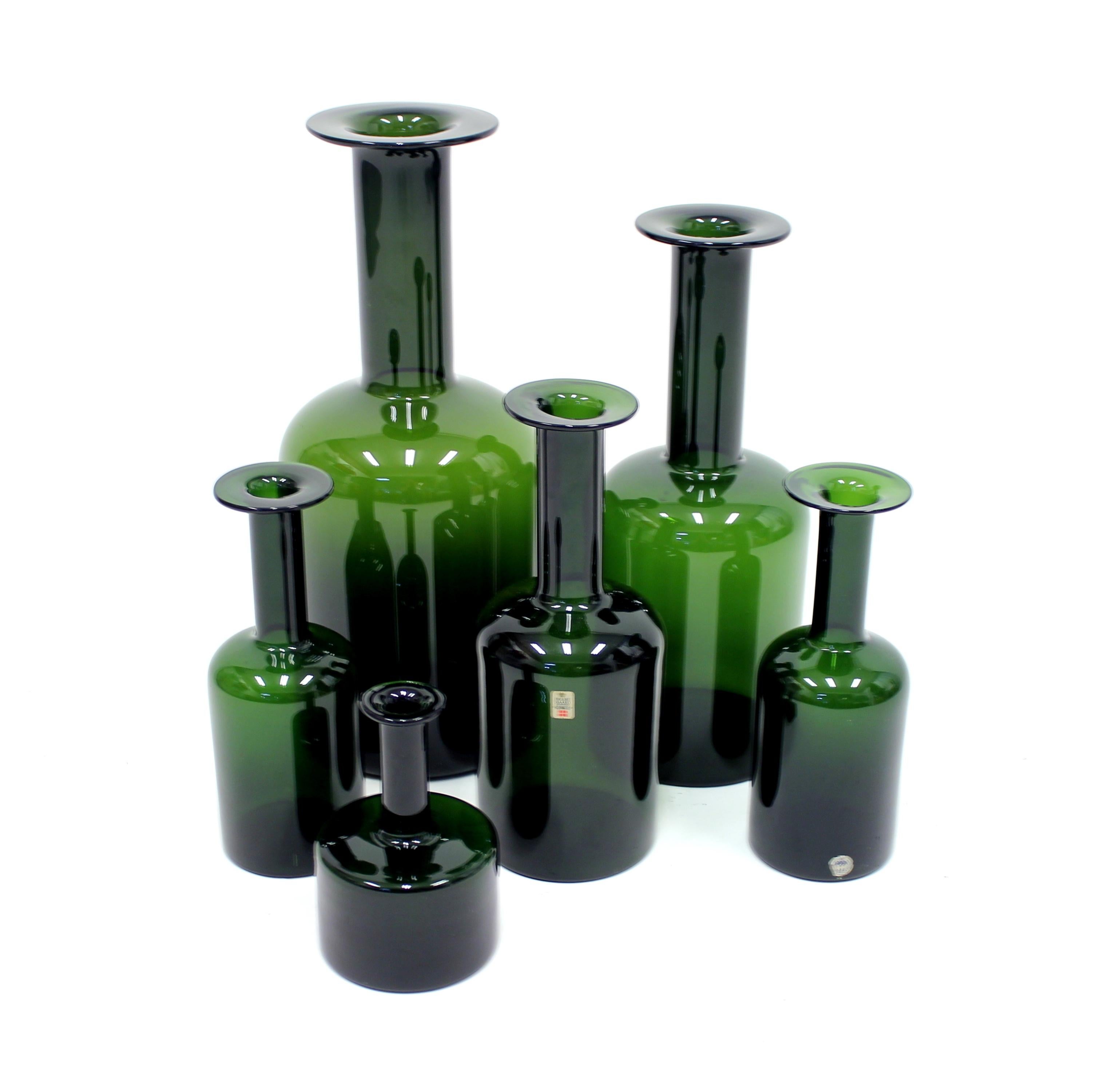 Set of 6 Holmegaard vases designed by Otto Brauer in a bottle green color. The set contains five different sizes with the height measuring between 17-44 cm. Two of the vases have the original Holmegaard sticker. Good vintage condition.