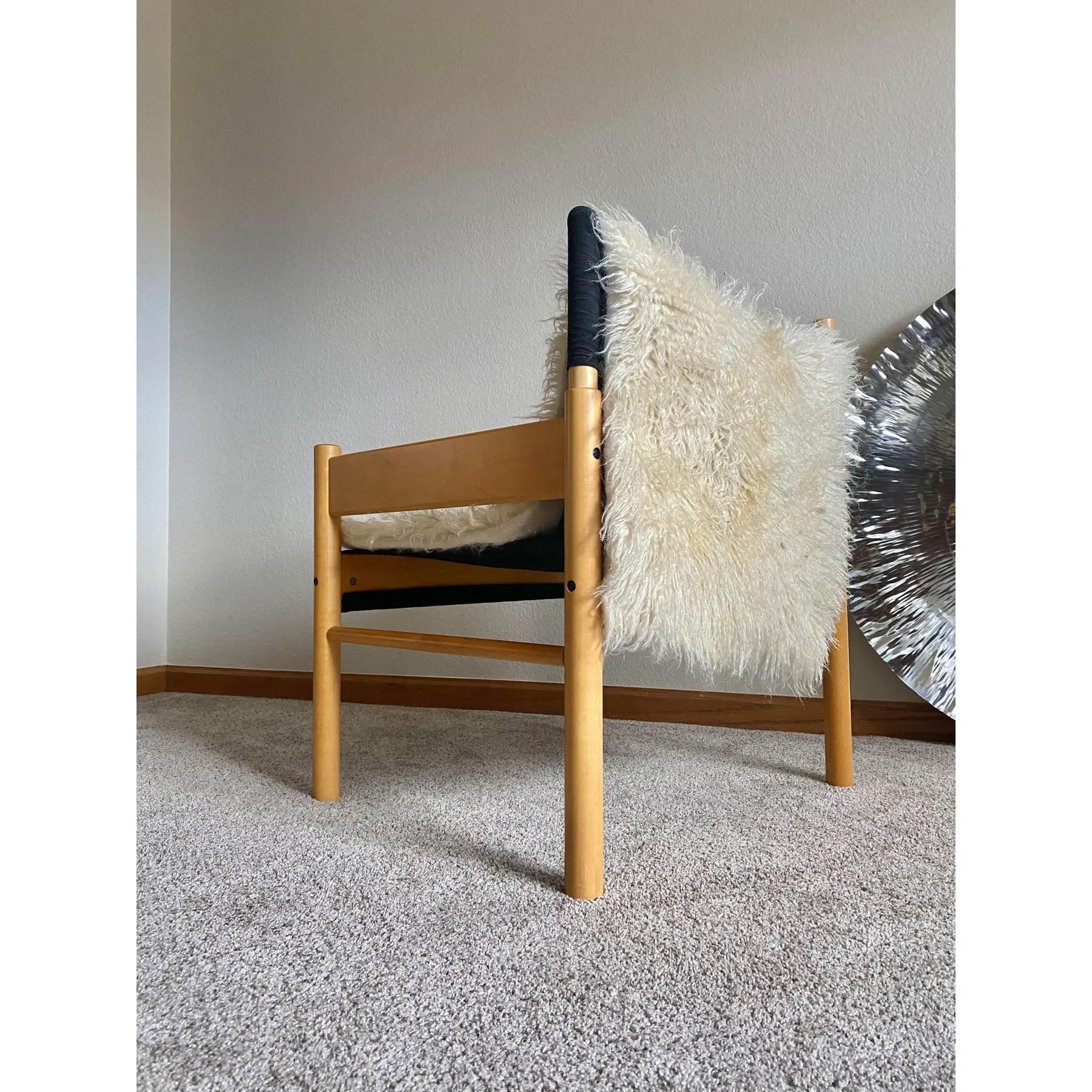 Minimalist beech armchair attributed to Otto Gerdau for Cimo (Brazil), featuring its original black cotton sling seat and an added vintage wool flokati throw styled over the sling. The solid beech construction showcases warm tone and subtle patina,