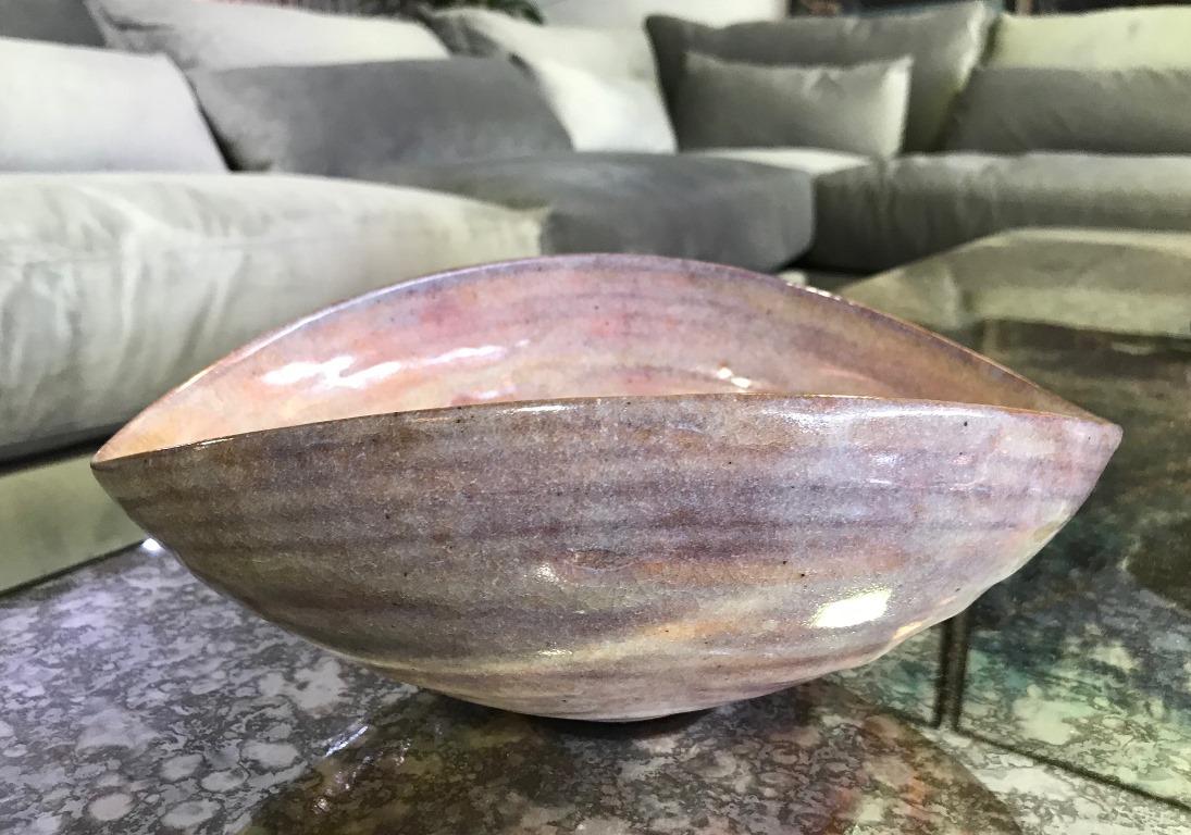 An absolutely sublime, quite riveting, unusually large early work by famed pottery masters Otto and Gertrud Natzler. This oval shaped, thin walled bowl with upturned sides was hand thrown and formed by Gertrud and glazed by Otto with a quite rare