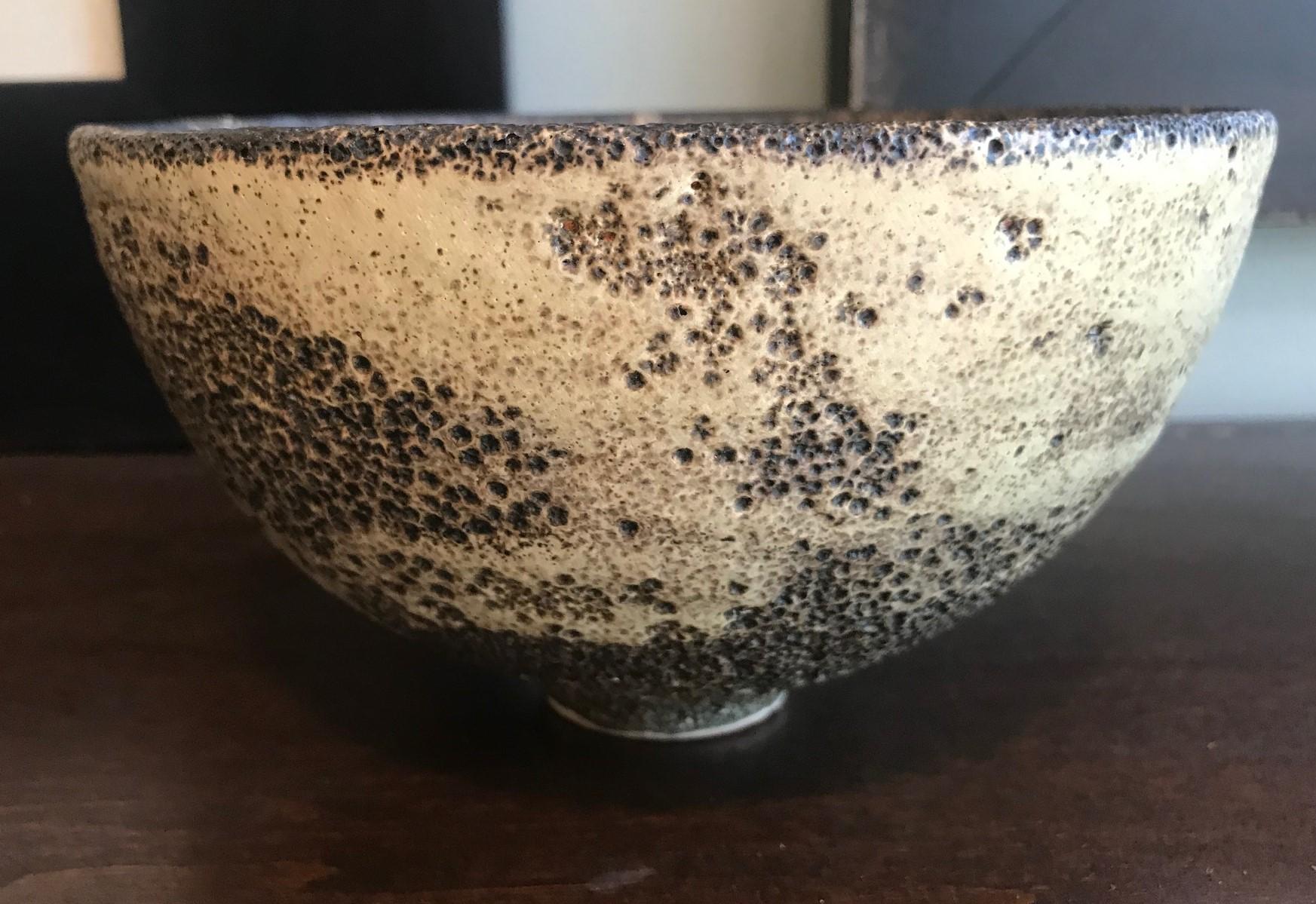 A masterful work by famed potters Otto and Gertrud Natzler. This round-shaped footed bowl was hand thrown and formed by Gertrud and glazed by Otto with one of his famed volcanic crater glazes. The bowl captures your attention from all angles.