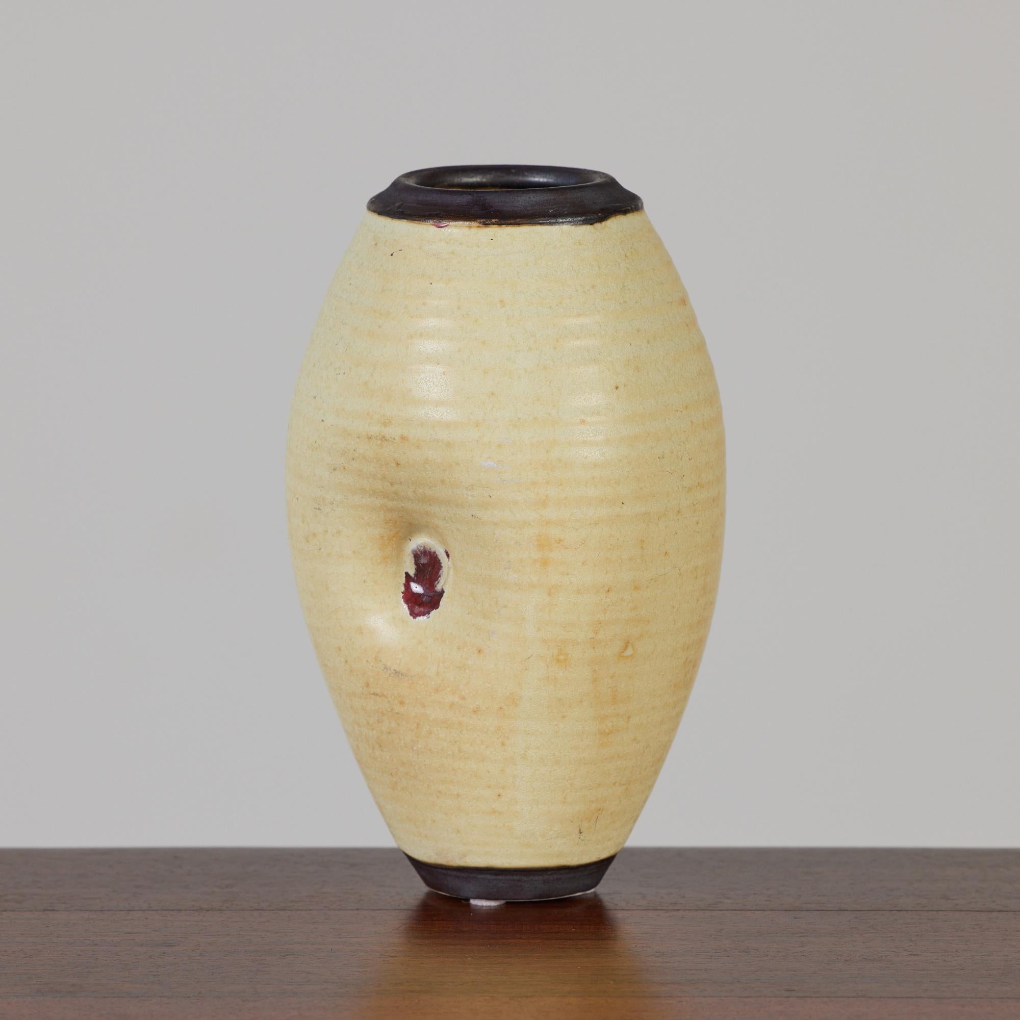 A small studio pottery vessel by significant 20th century ceramicist Otto Heino. This piece features the buttery yellow glaze Heino perfected after his wife’s death, a continuation of her long-running project to reproduce a lost glaze recipe from