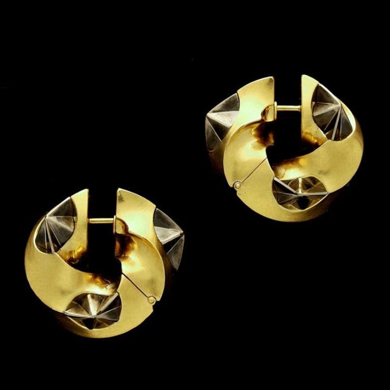 A pair of 'Ninigi L' earrings in 18ct yellow and white gold by Otto Jakob, finely modelled as wide gold spiralled hoops embellished with partially oxidized white gold limpet like motifs.

Maker
Otto