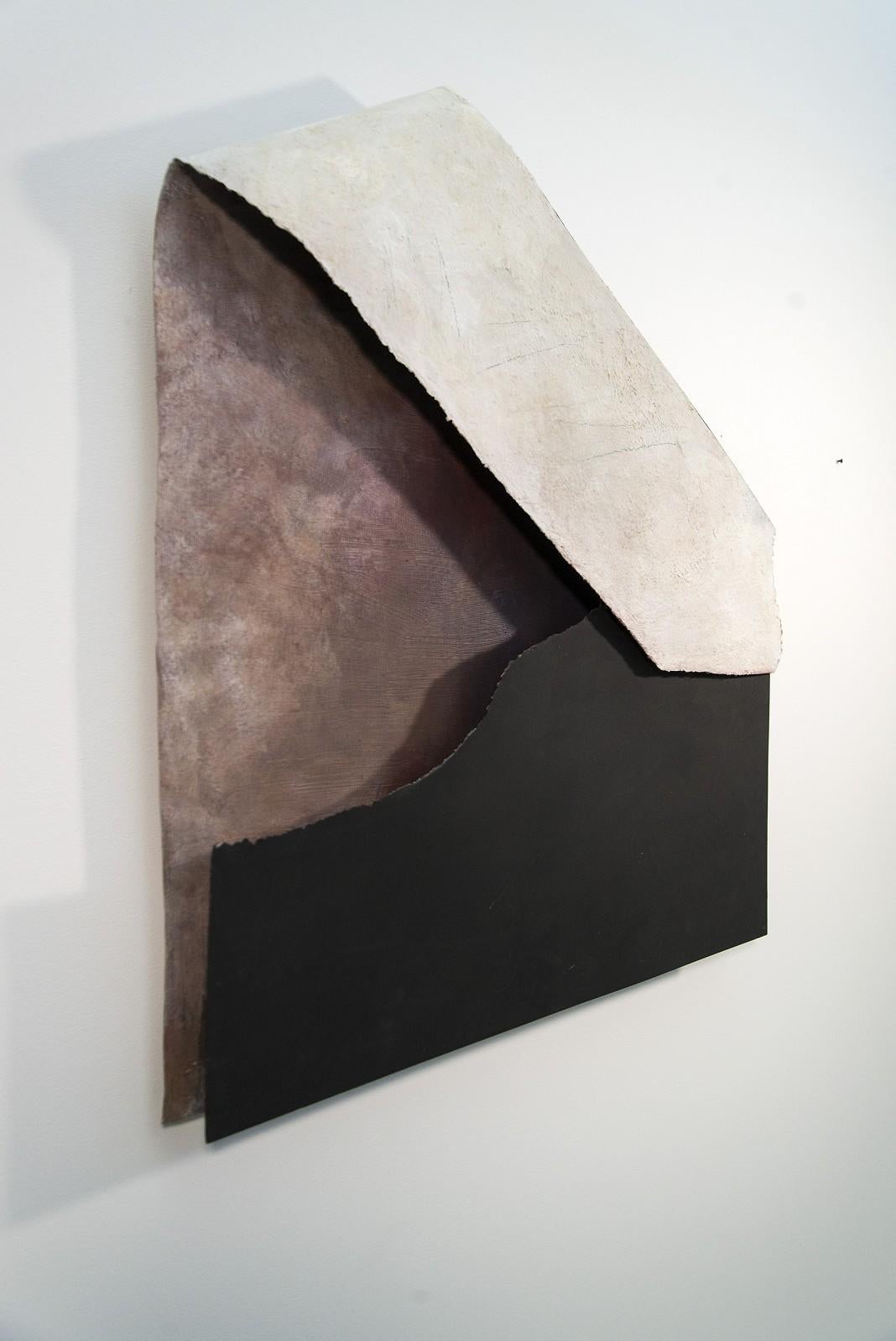 This simple, elegant composition by abstract artist Otto Rogers is mixed media and metal. The white letter contrasts against the earthy palette and the soft gray background. 

Saskatchewan born Rogers (1935-2019) was recognized by the NY art critic,