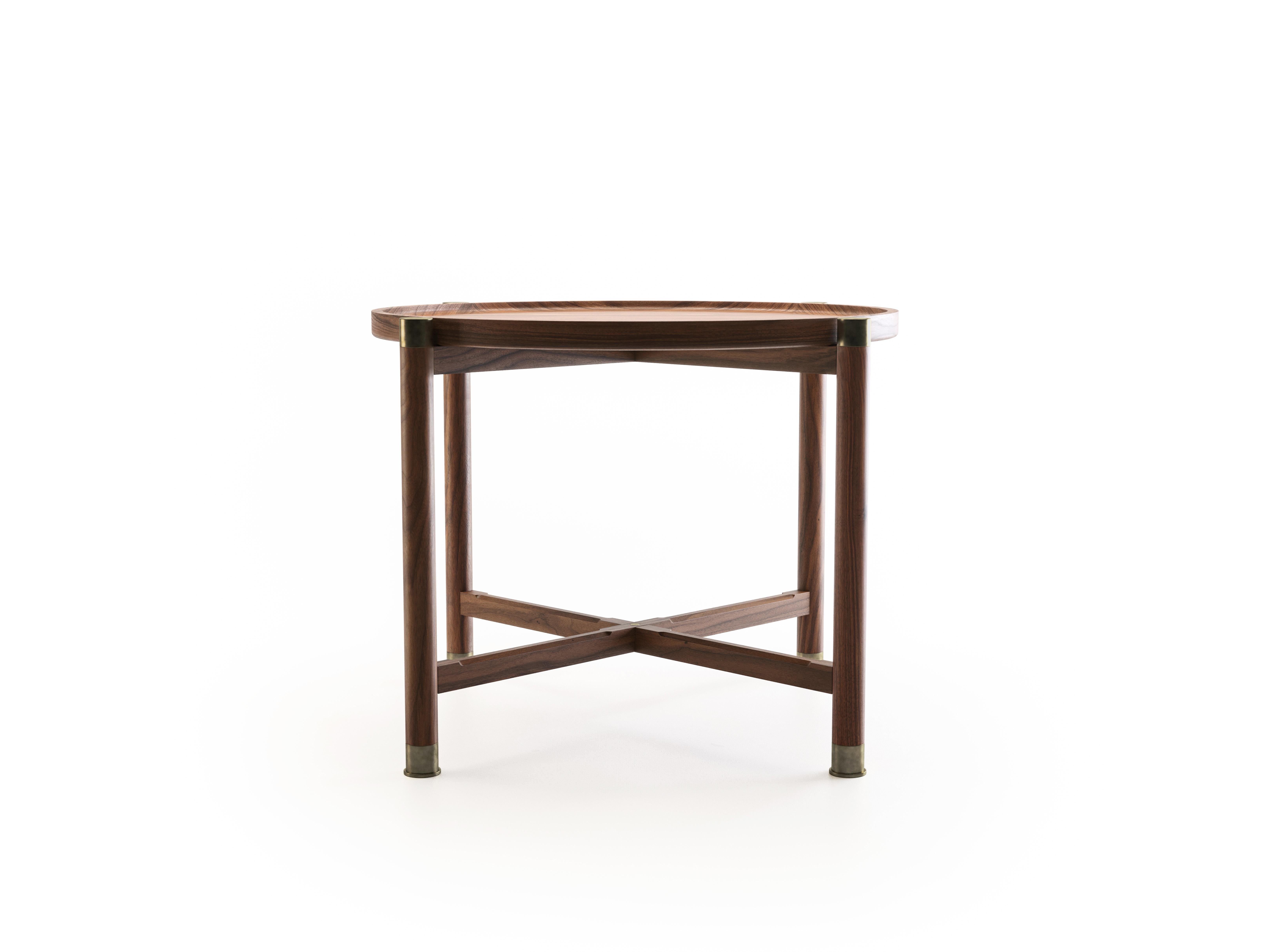 The Otto side table is a generously proportioned table with a simple, well-articulated form.
Available in walnut or oak, it features a round coupe top, substantial antique brass fittings, and sleek chamfered stretchers. The epitome of understated