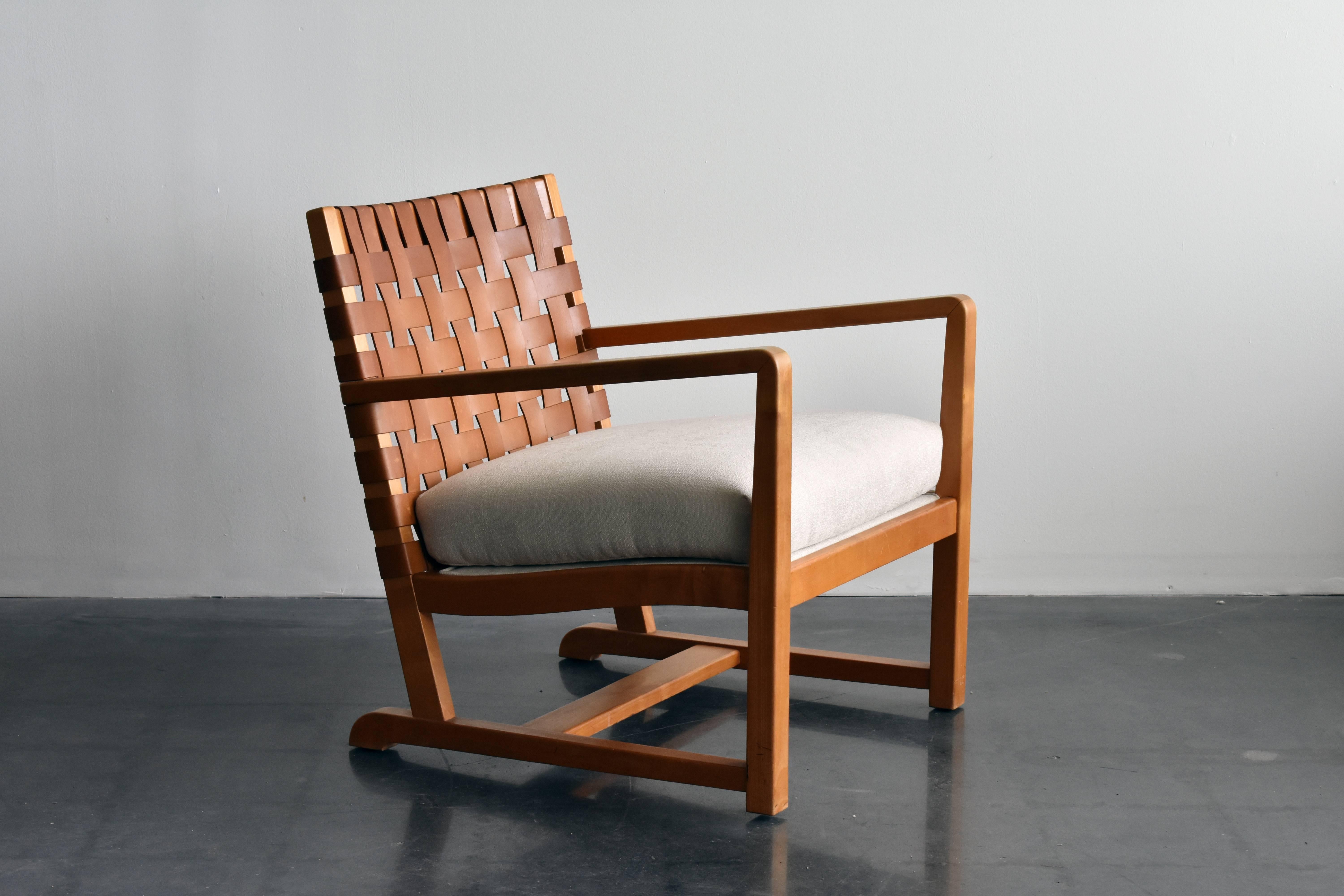 A lounge chair designed by Otto Schultz in 1938 for Boet. Executed in stained birch, back with original braided natural leather that has acquired patina. Original seat cushion reupholstered in a high end off-white fabric. See last image for