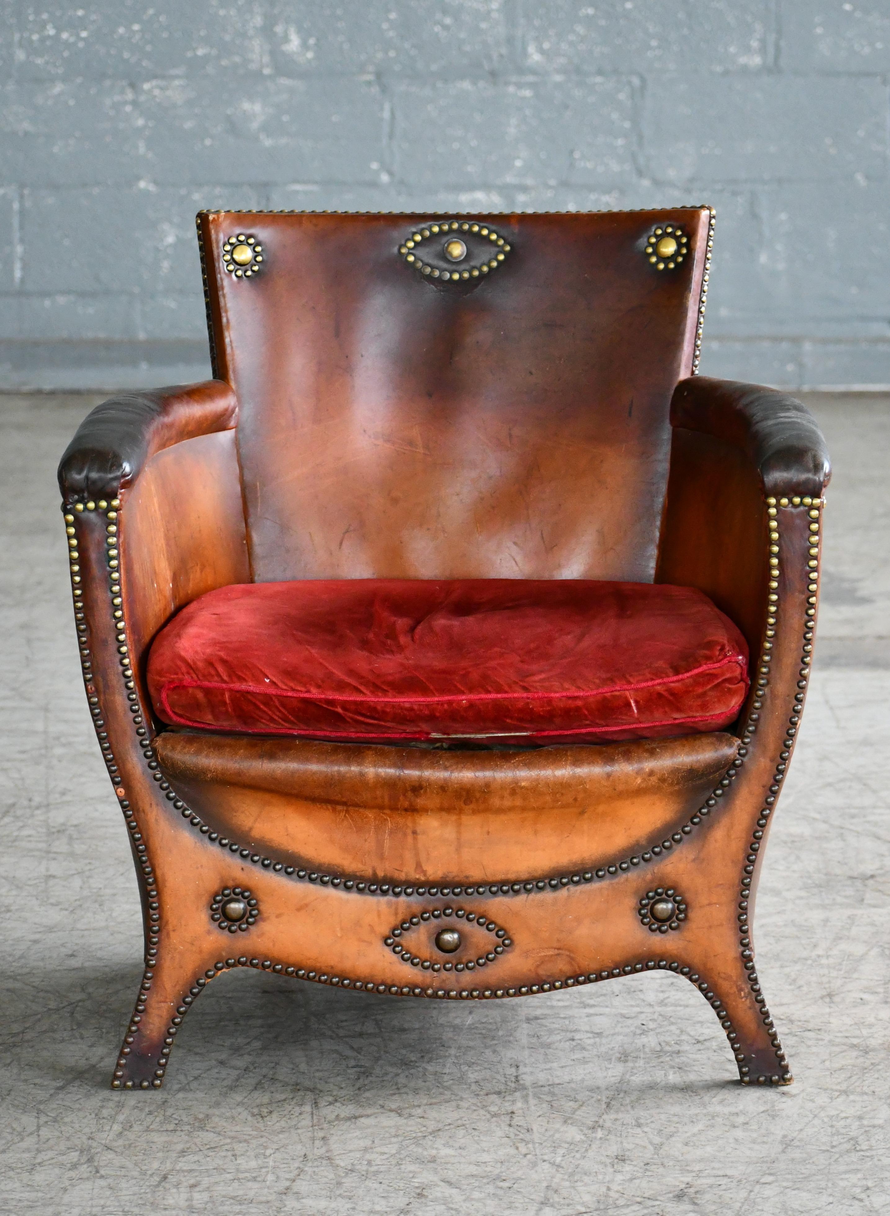 Superb 1930s-1940s baroque-style lounge chair attributed to Otto Schulz designed for Boet - Schulz' own high-end retail store in Gothenburg, Sweden. The chair in leather and birch wood is very representative of his innovative low swung baroque