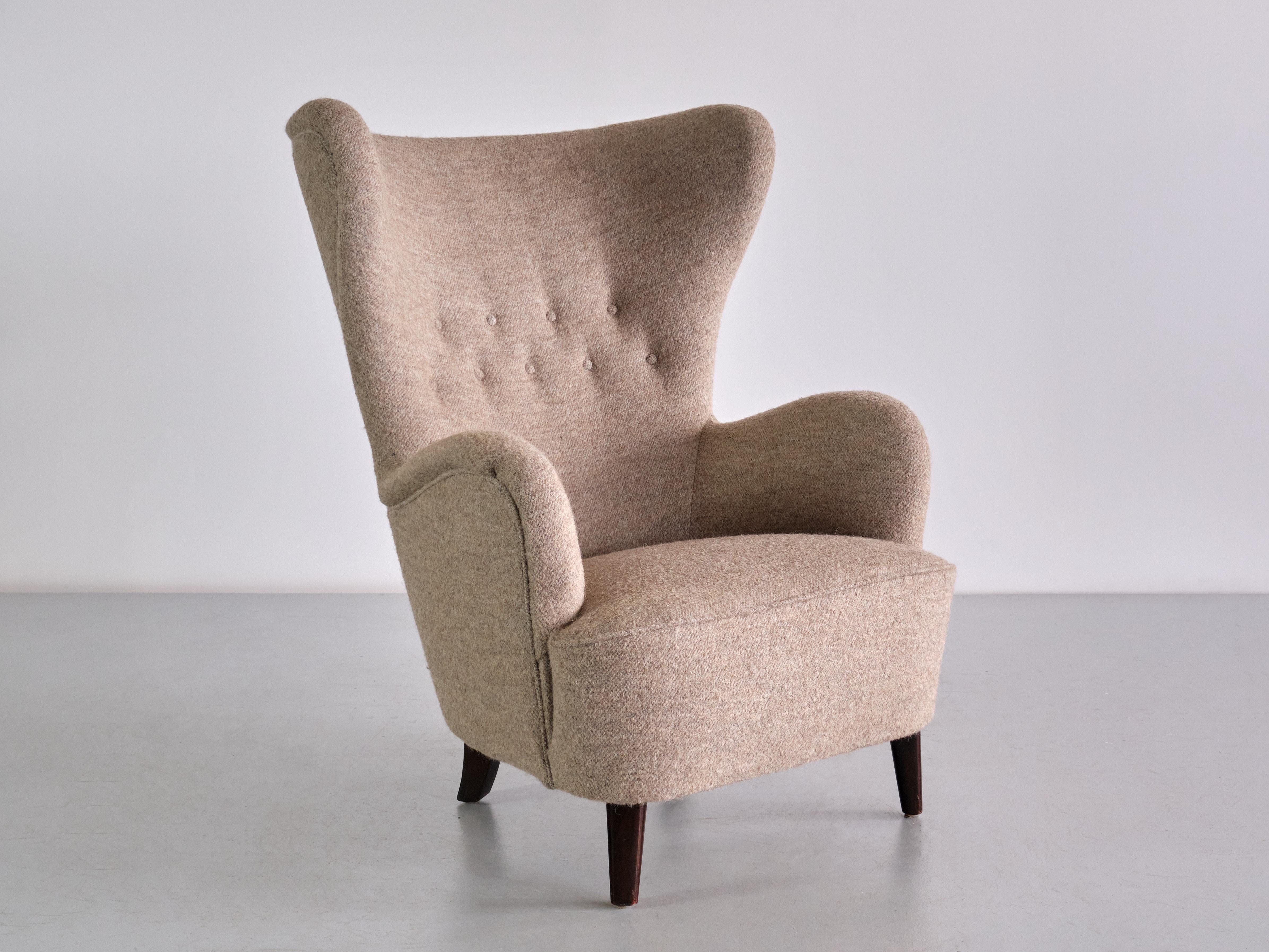 This exceptionally rare armchair was designed by Otto Schulz and produced by Boet in Goteborg, Sweden in the 1940s. The rounded, organic lines of the design create a striking silhouette. Its generous proportions and the high, buttoned back make this