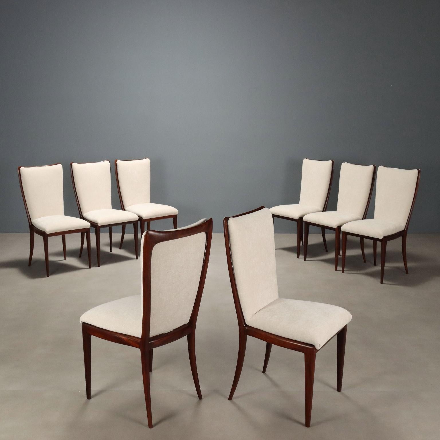 Groupe de huit élégantes chaises de salle à manger de fabrication italienne, avec une structure en bois de hêtre teinté, une assise et un dossier rembourrés et un tissu dans des tons blancs. Restauré dans la partie en bois. 