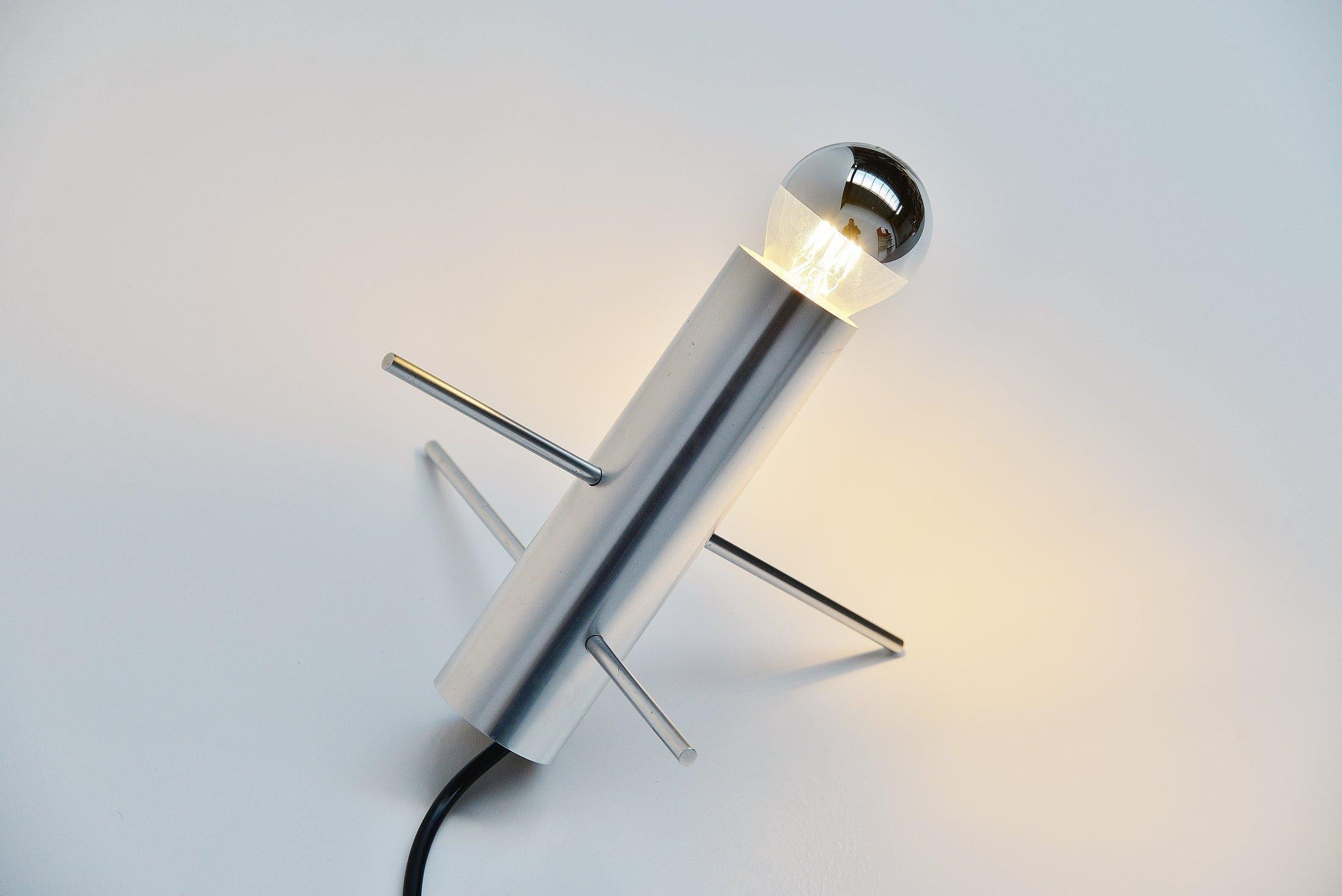 Fantastic Minimalist table lamp designed by Otto Wach and manufactured by RAAK Amsterdam, Holland 1960. This is for sure one of my favourite designs from the RAAK collection. The lamp is highly decorative and yet so simple. Made of an aluminium tube