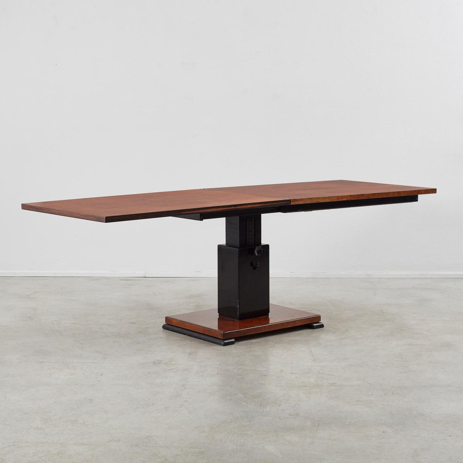 An extendable rosewood table with wonderful presence by Swedish designer, furniture maker and architect Otto Wretling. When opened it reveals a generous burr-veneered surface. The table can be raised or lowered via a clever ratchet system.

Good