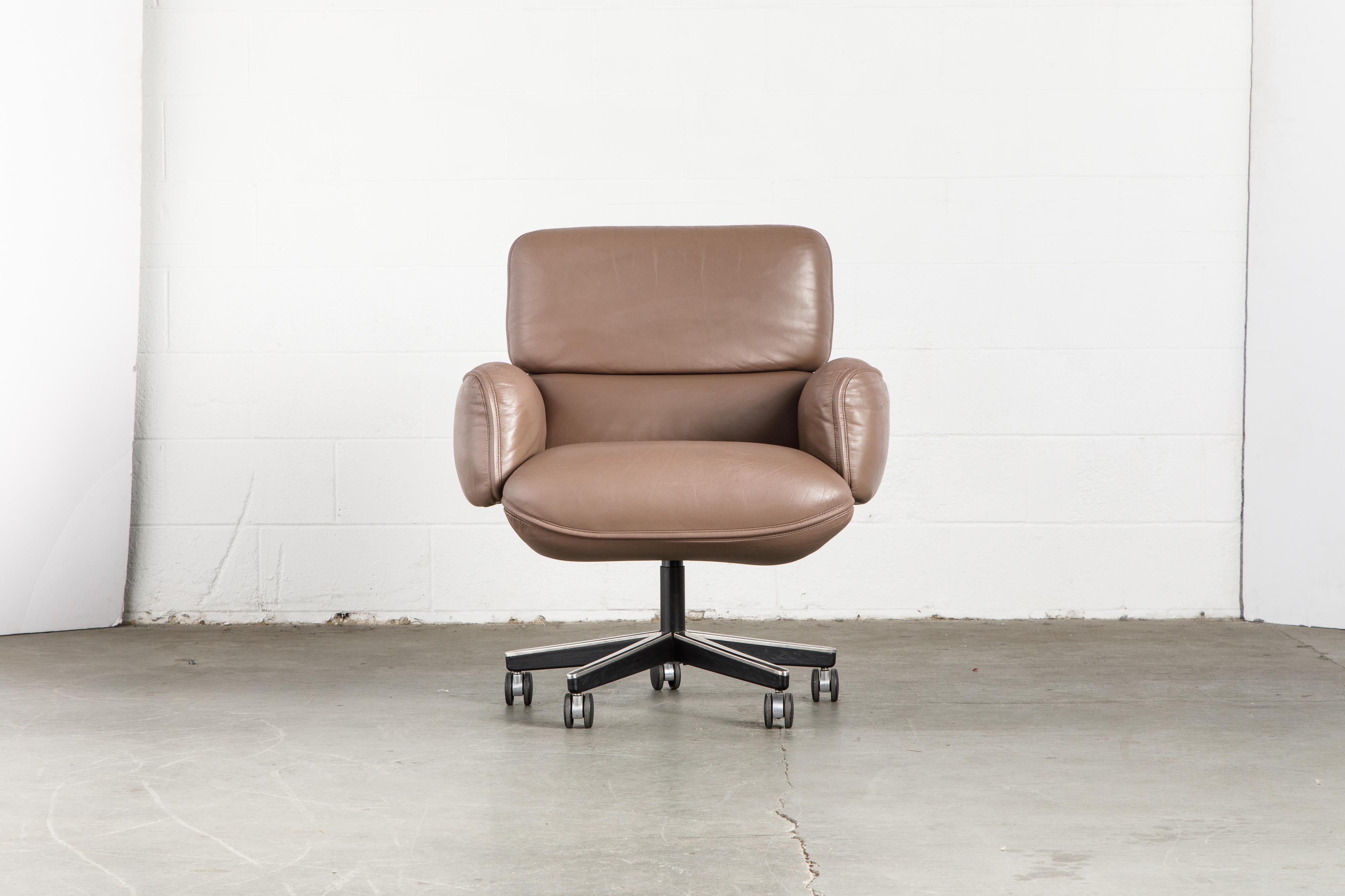 This gorgeous leather executive management desk chair is by Otto Zapf for Knoll International, circa 1985. Constructed of heavily cushioned sections, with the top head section and arms removable. The chair base is height and tilt / recline