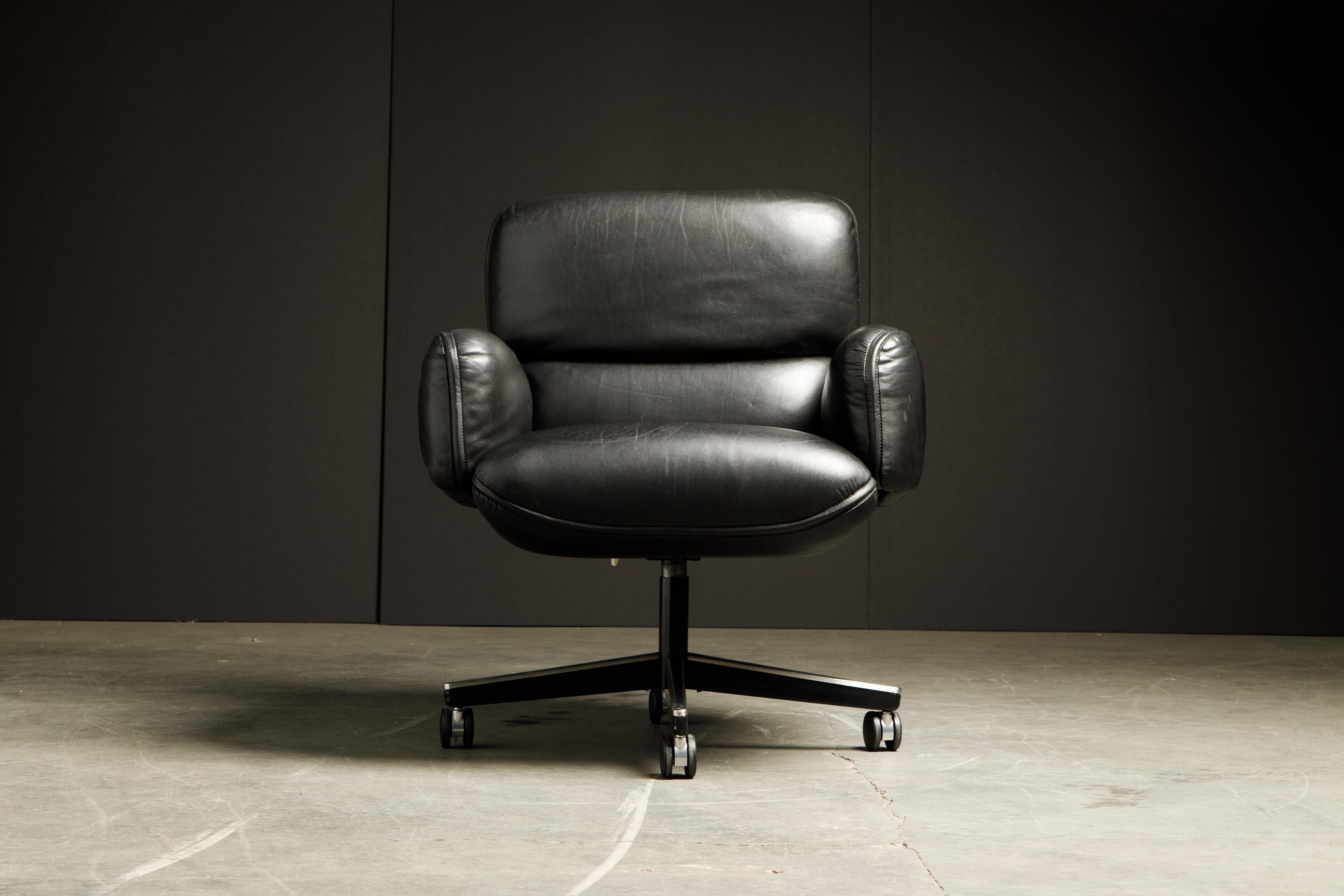 This gorgeous black leather executive management desk chair is by Otto Zapf for Knoll International, circa 1985. Constructed of heavily cushioned sections, with the top head section and arms removable. The chair base is height and tilt / recline