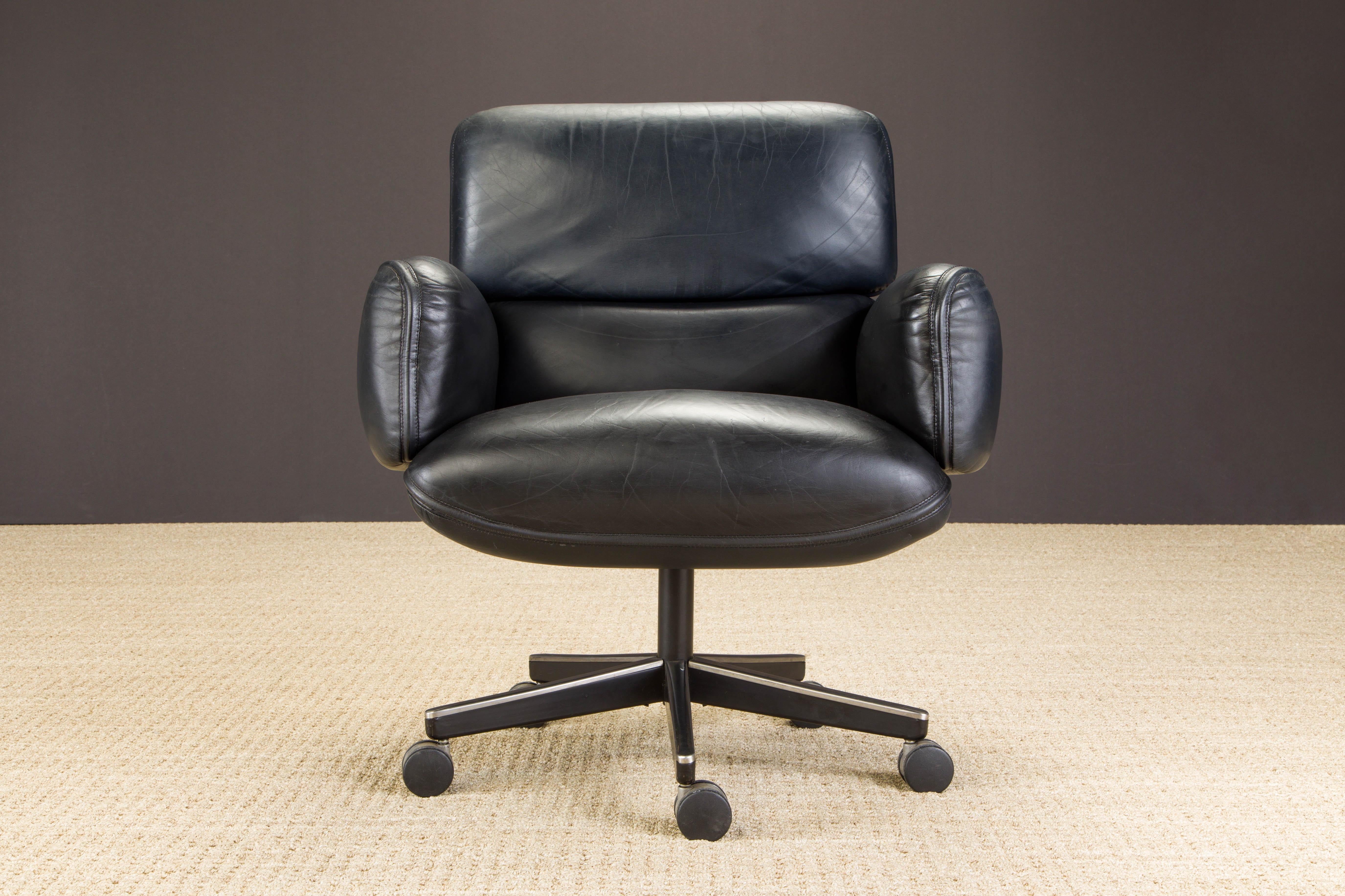 This gorgeous leather management desk chair is by Otto Zapf for Knoll International, circa 1985, signed with Knoll International label. Constructed of heavily cushioned sections, with the top head section and arms removable. The chair base is height