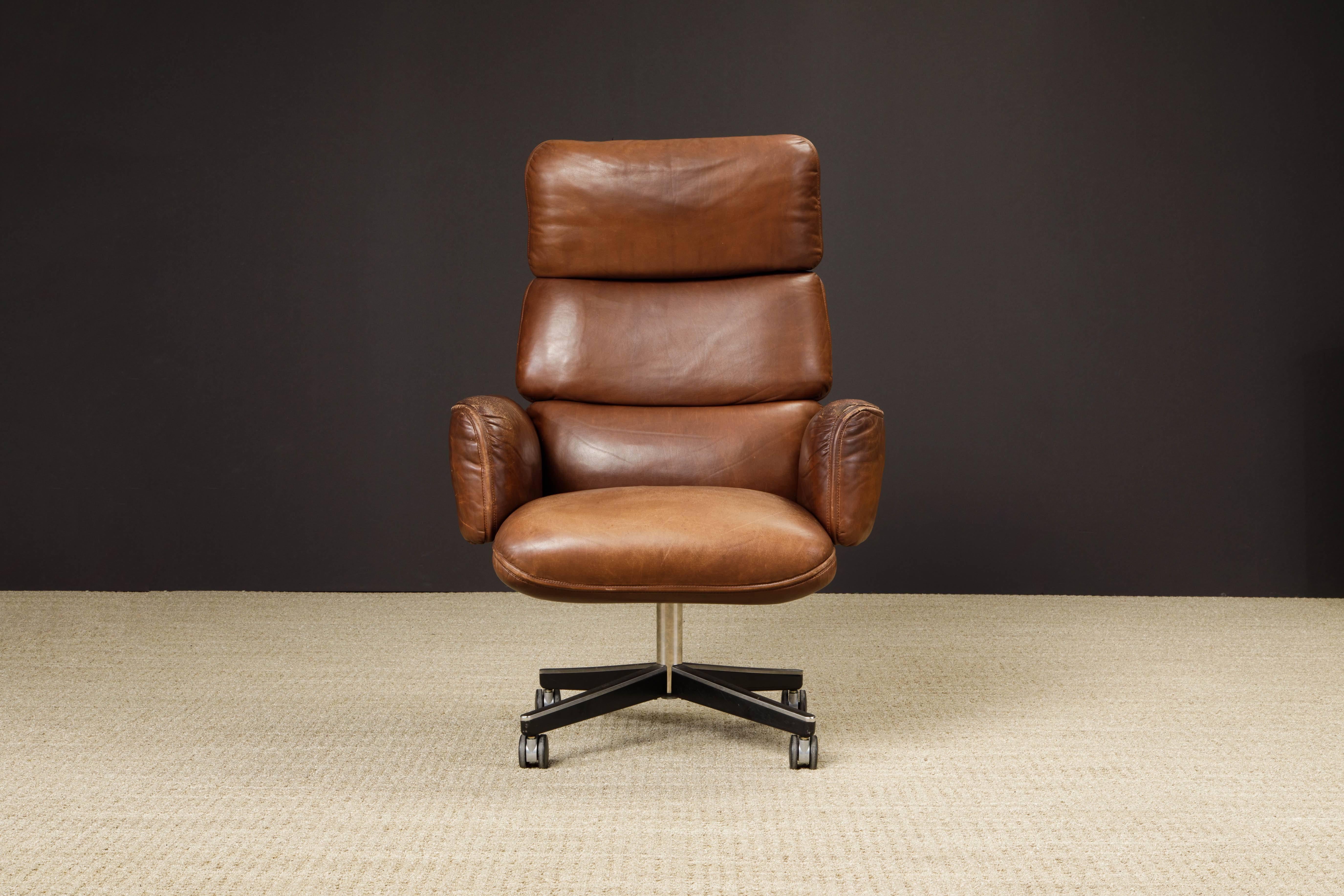This gorgeous highly patinated brown leather highback executive desk chair is by Otto Zapf for Knoll International, circa 1979, signed with early Knoll International label. Constructed of heavily cushioned sections, with the top head section and