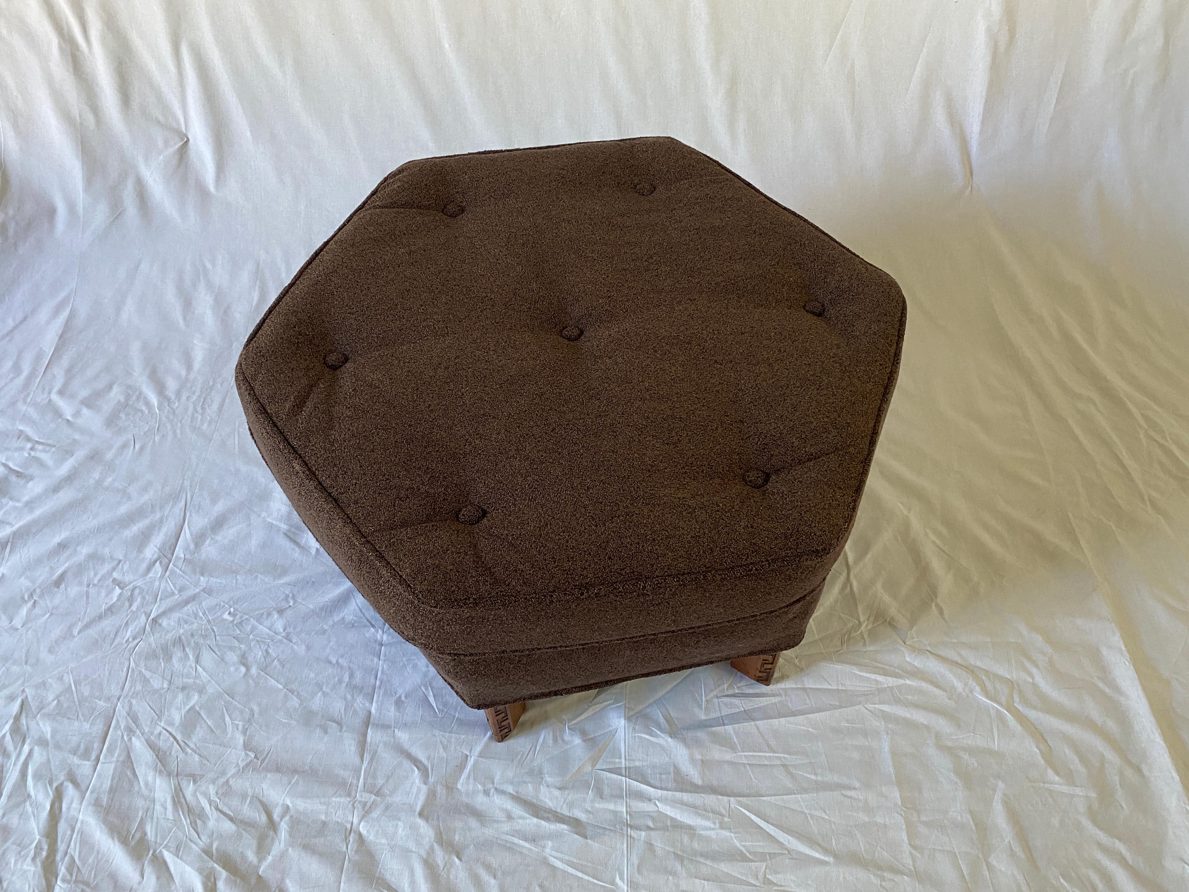 A Frank Lloyd Wright hexagonal ottoman with a semi attached seat cushion, rising on geometric Taliesin styled mahogany legs. Reupholstered in an all bamboo pile textile from Pollack.
  