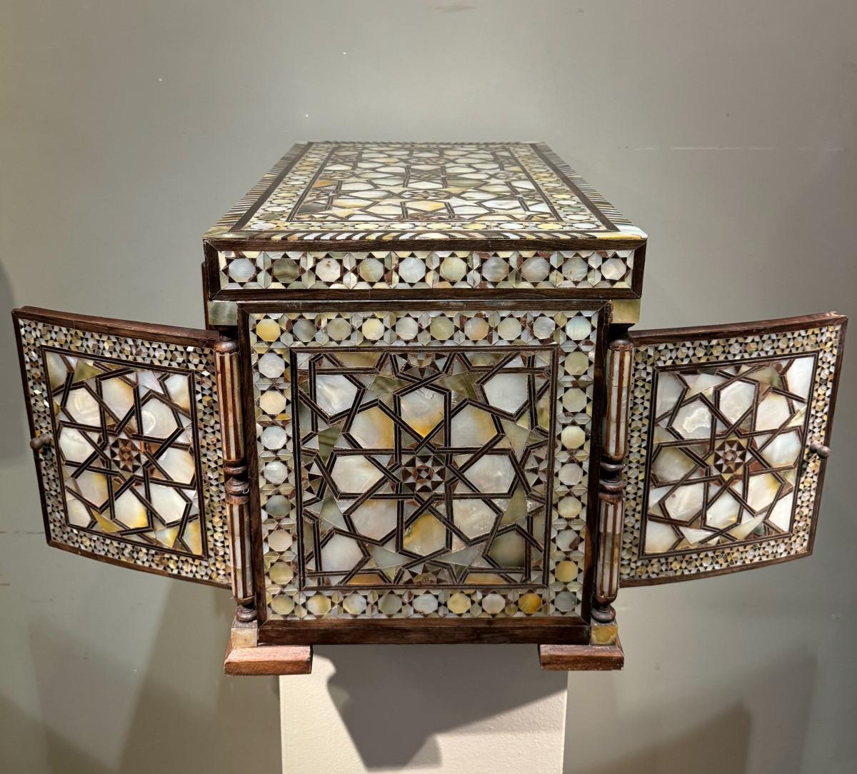 Beautiful and rare Ottoman cabinet opening on both sides and on the top.
Six drawers inside and a mirror door on each side.
Decorated with mother-of-pearl geometric patterns on all five sides.
Some wear, but overall good condition.
The four feet on