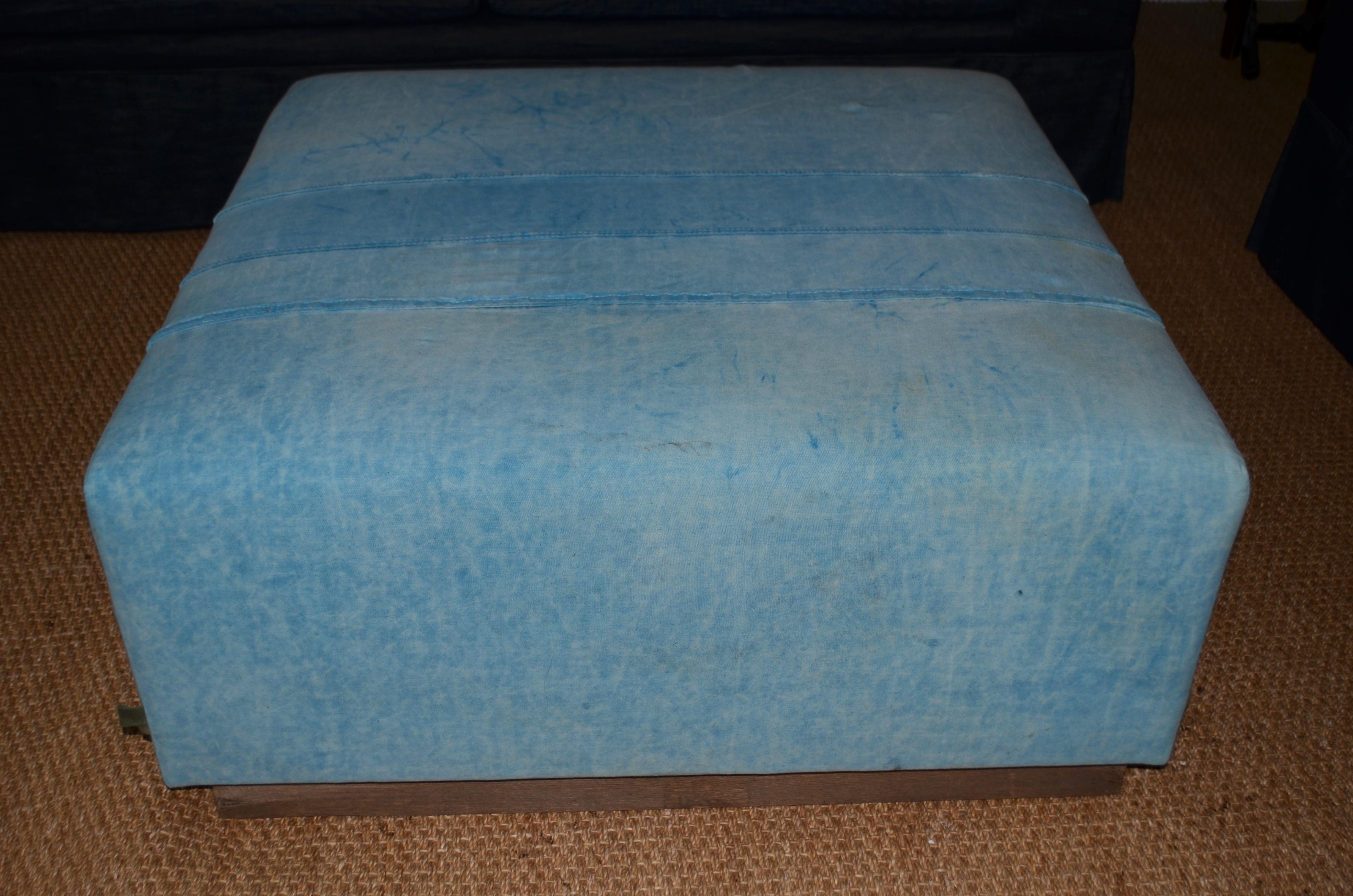 Ottoman upholstered in 1960s tent canvas. Sits sturdily atop handcrafted, 100-year old barn wood base, left in its natural weathered state. A sizable, sophisticated, room-presence piece. Sit on it, rest your feet upon it, spread a tablecloth and set