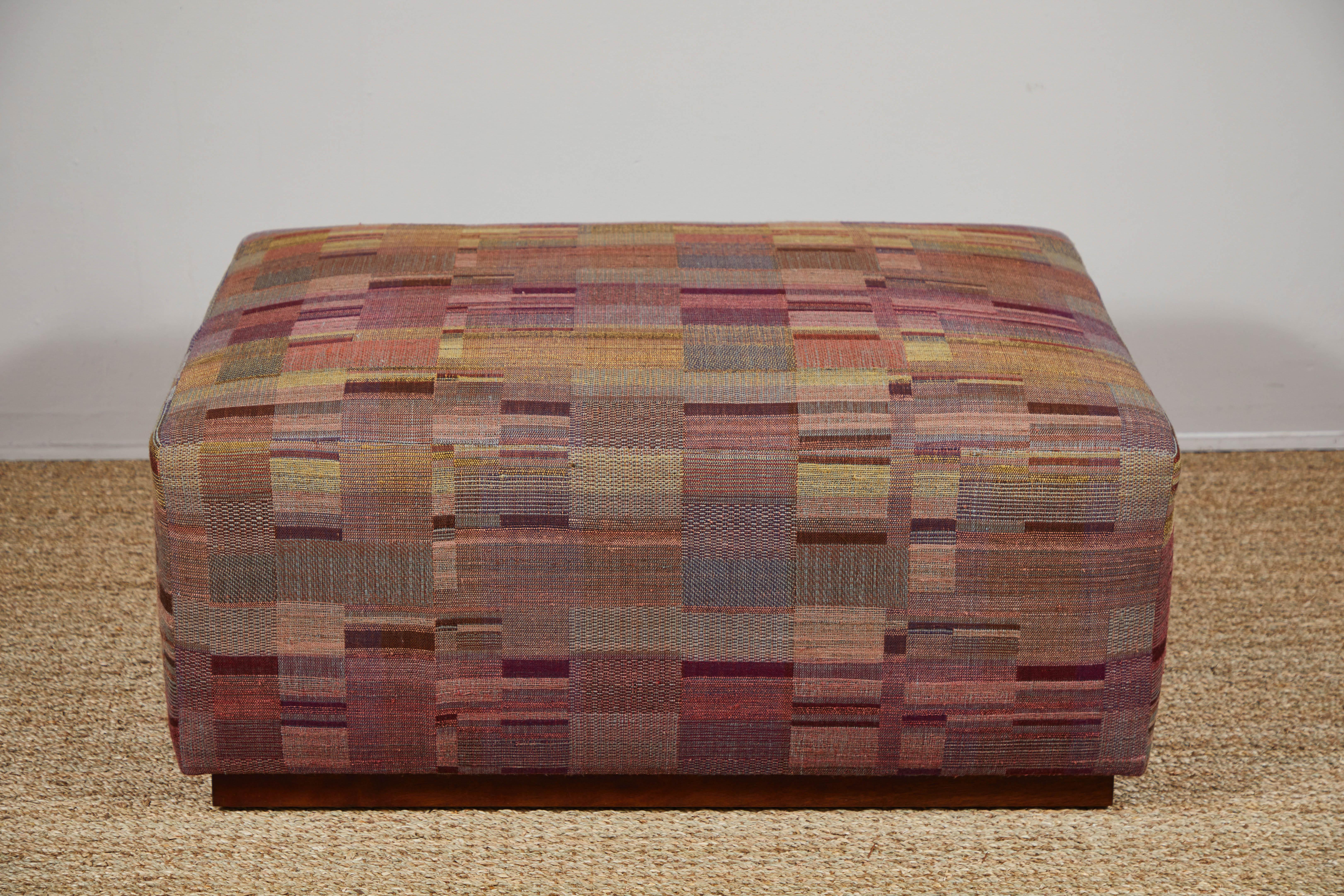 Contemporary ottoman on wheels covered in Pat McGann Studio raw tussar silk and wool fabric. Fabric and ottoman available to order.
