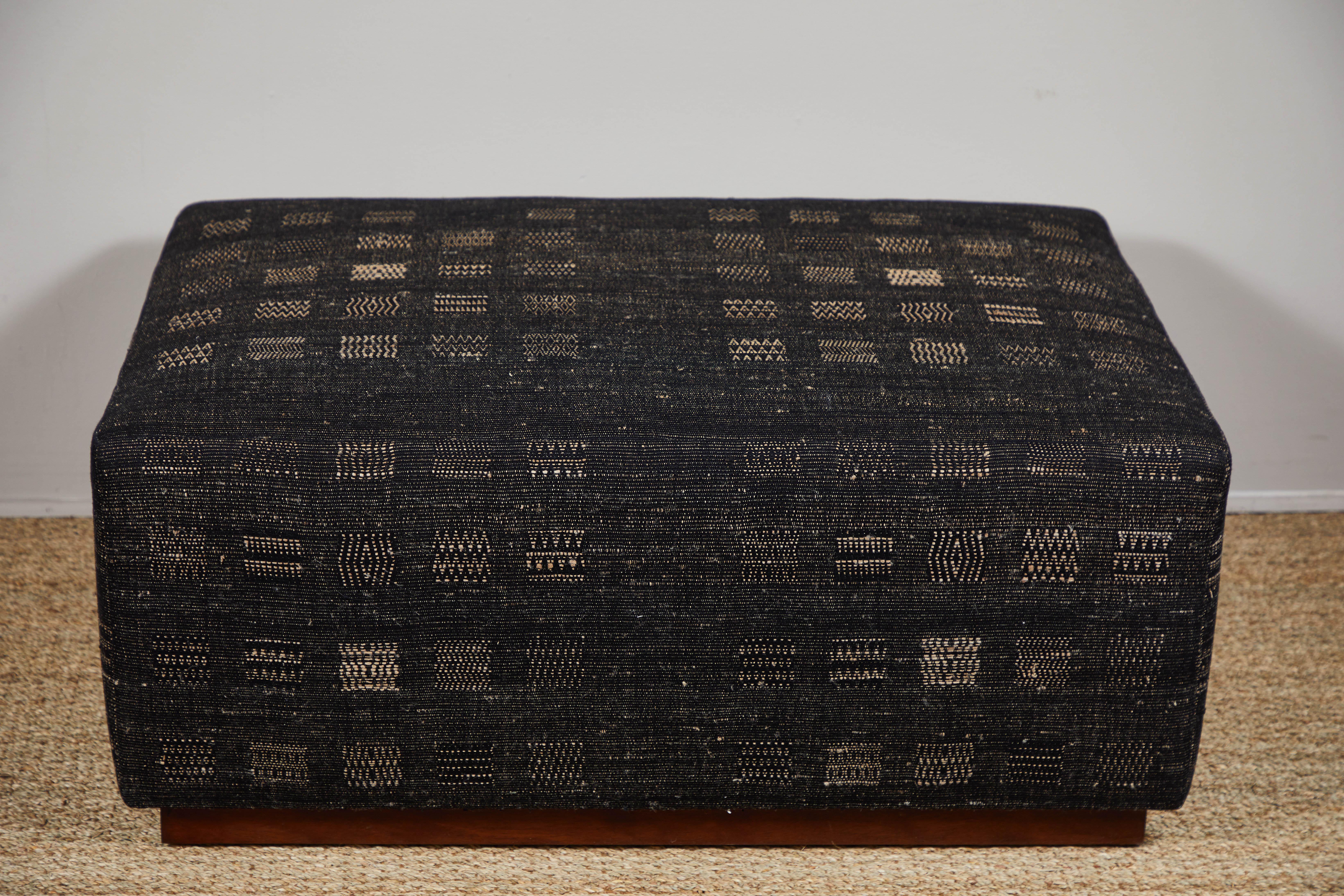 Contemporary ottoman on wheels covered in Pat McGann Studio raw tussar silk and cotton upholstery fabric. Upholstery weight fabric and ottoman available to order.
    