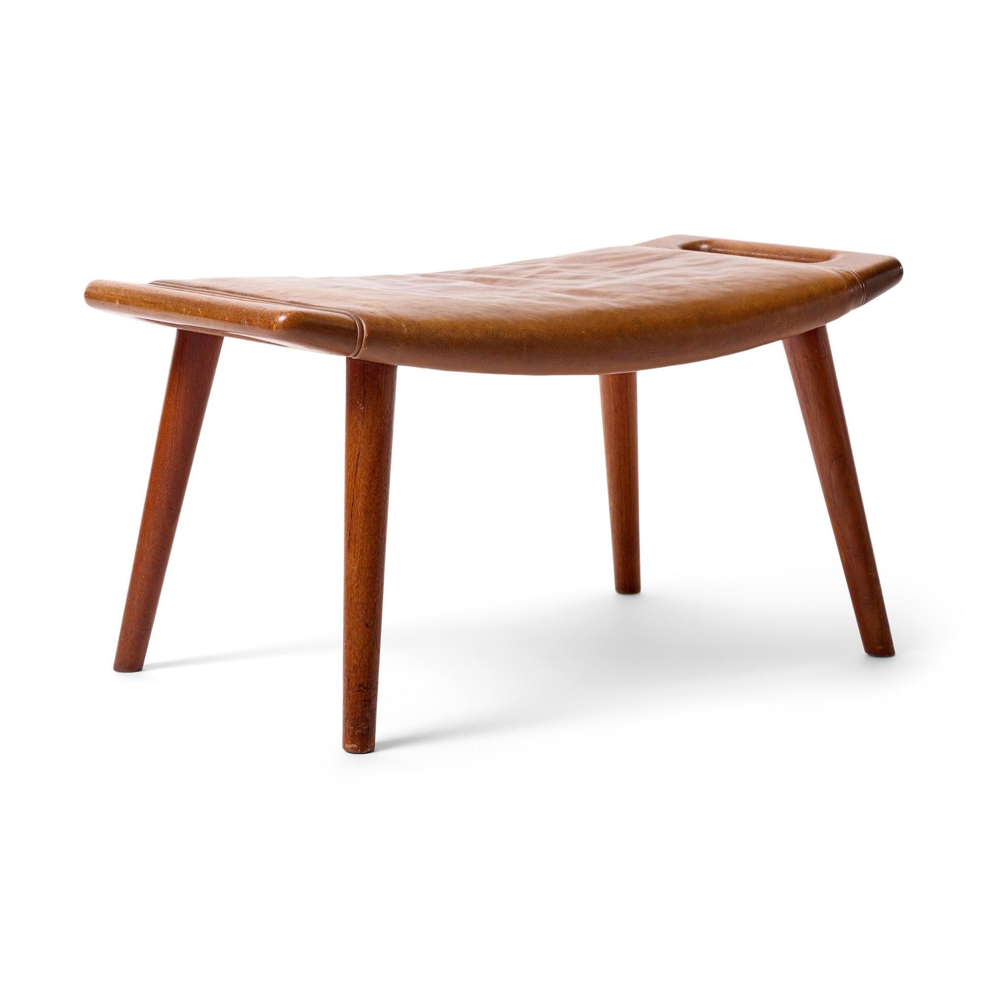 Pouf/sgabello in teak con maniglie intergrali e gambe a tasselli affusolati.