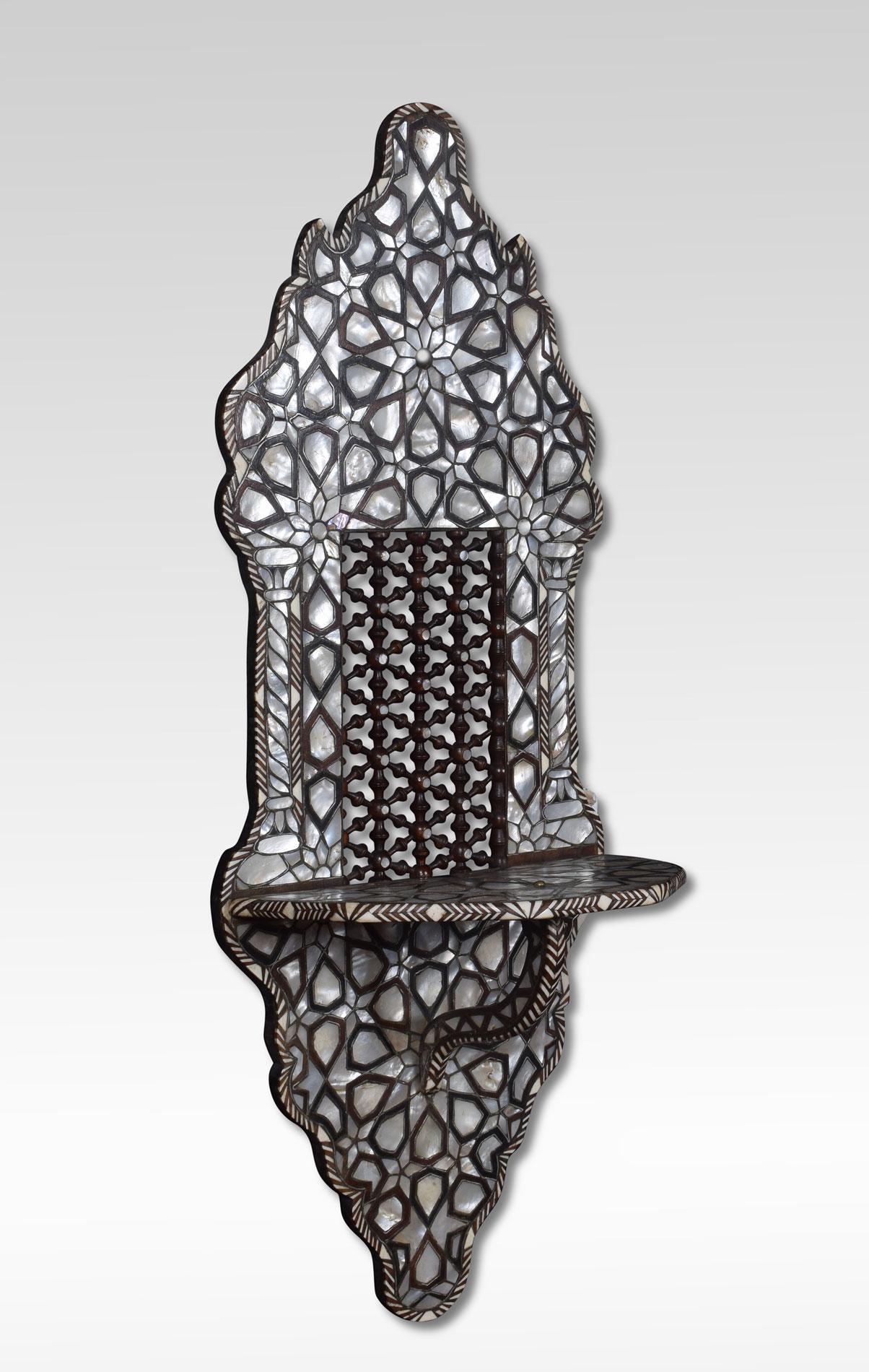 Ottoman wall bracket with geometric inlays of mother of pearl, bone, and exotic hardwoods. Having an architecturally intriguing form stick and ball panel, and ebonized shelf.
Dimensions:
Height 34.5 inches
Length 13.5 inches
Width 8 inches.
