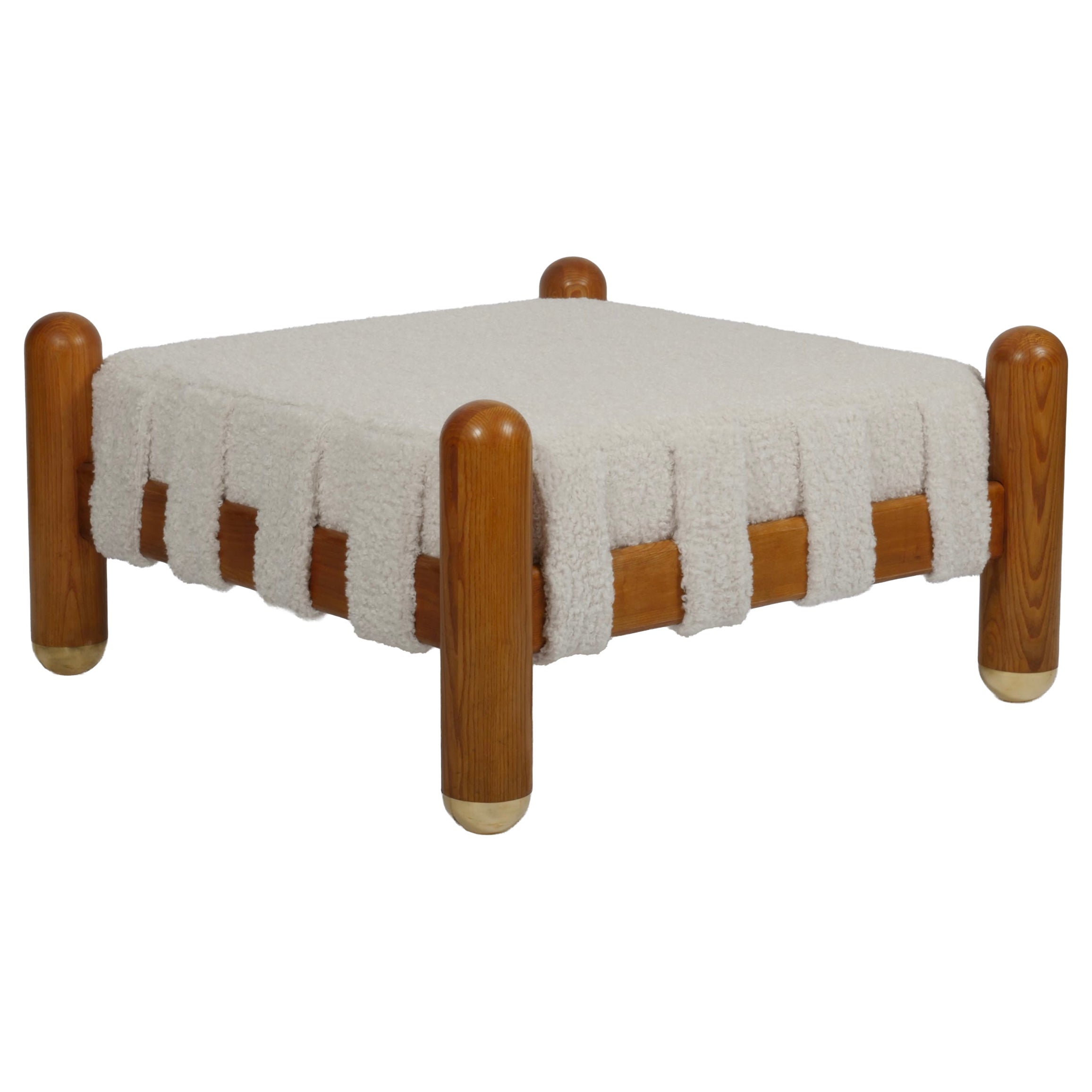 Ottoman in wool boucle, wood and brass