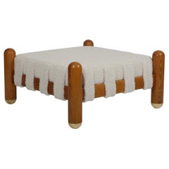 Ottoman in wool boucle, wood and brass