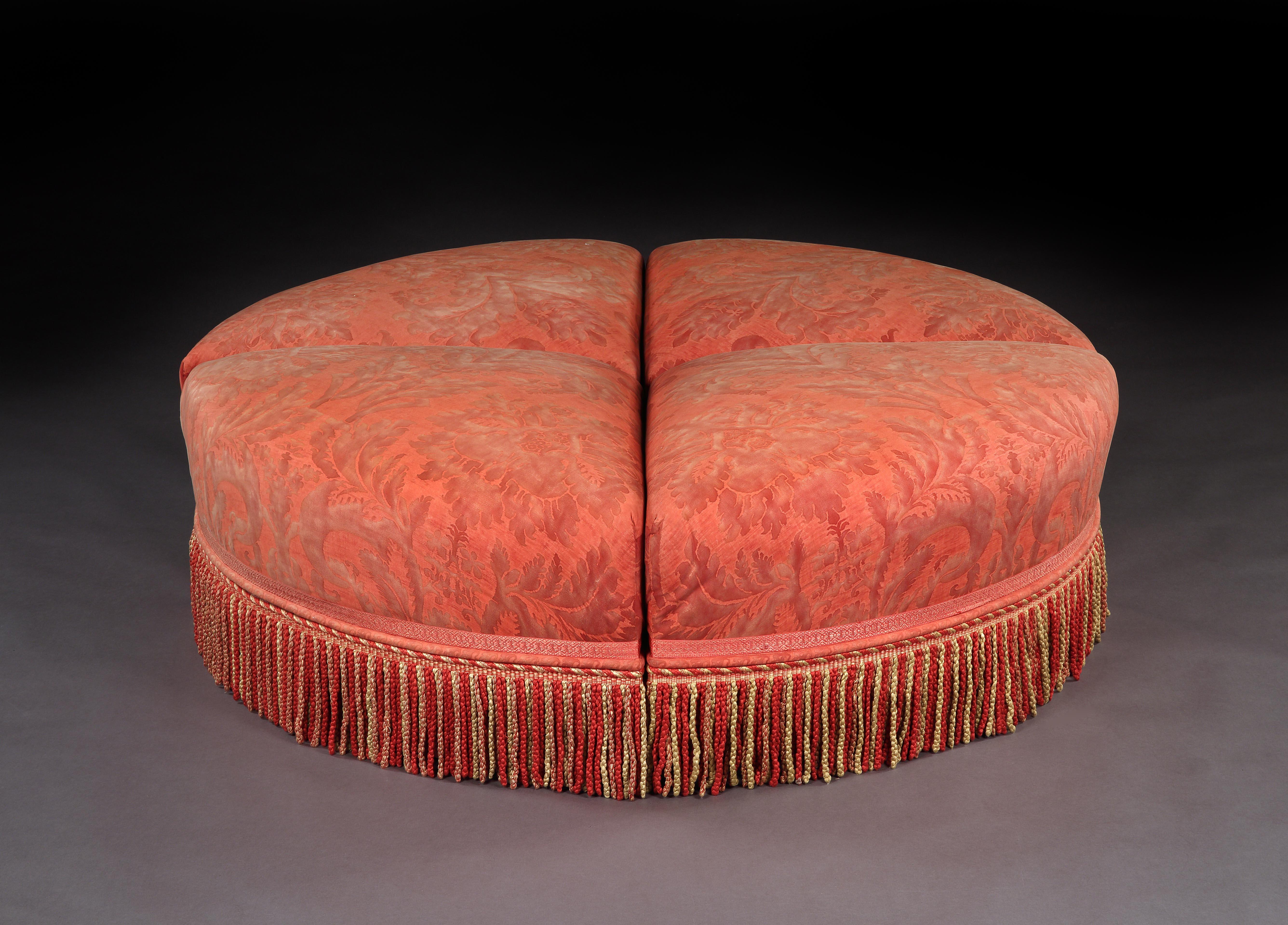 This beautiful, large, ottoman is extremely versatile as it comprises four individual sections which can be used as independent two-seat ottomans/pouffes/stools which fit together to form a large circular ottoman or pouffe or sofa table to support a