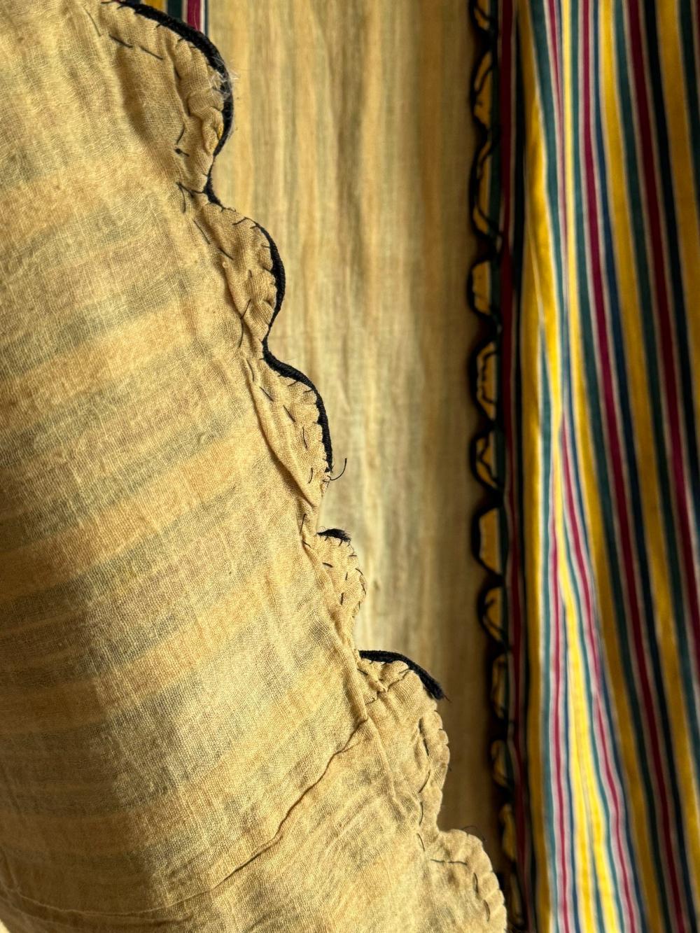 A 19thC Ottoman Robe, with scalloped edges made in striped cotton.
L 135cm
W arms 140cm