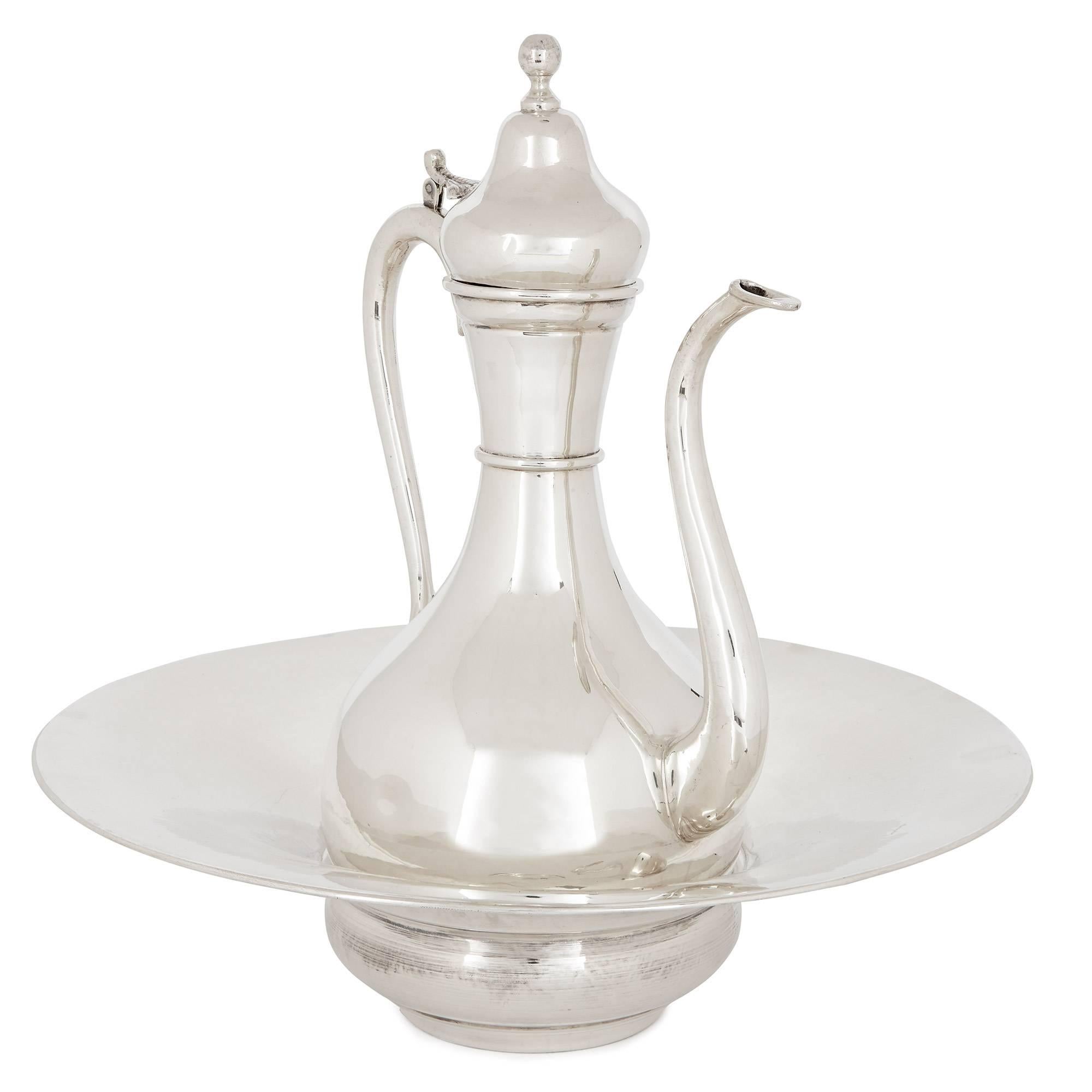 This silver ewer and basin, originally designed for handwashing before meals and for important occasions, is a beautiful piece of Turkish craftsmanship, in the Ottoman style. Crafted from solid silver, the ewer is elegantly shaped with a round base