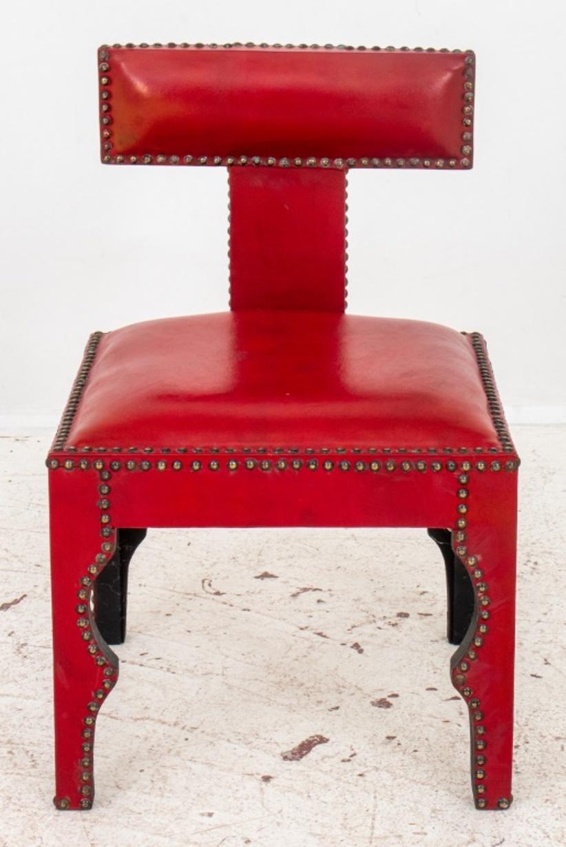Ottoman Turkish Style red leather upholstered chair, the seams decorated with nailheads, the shaped back above square seat and shaped apron and four legs.26