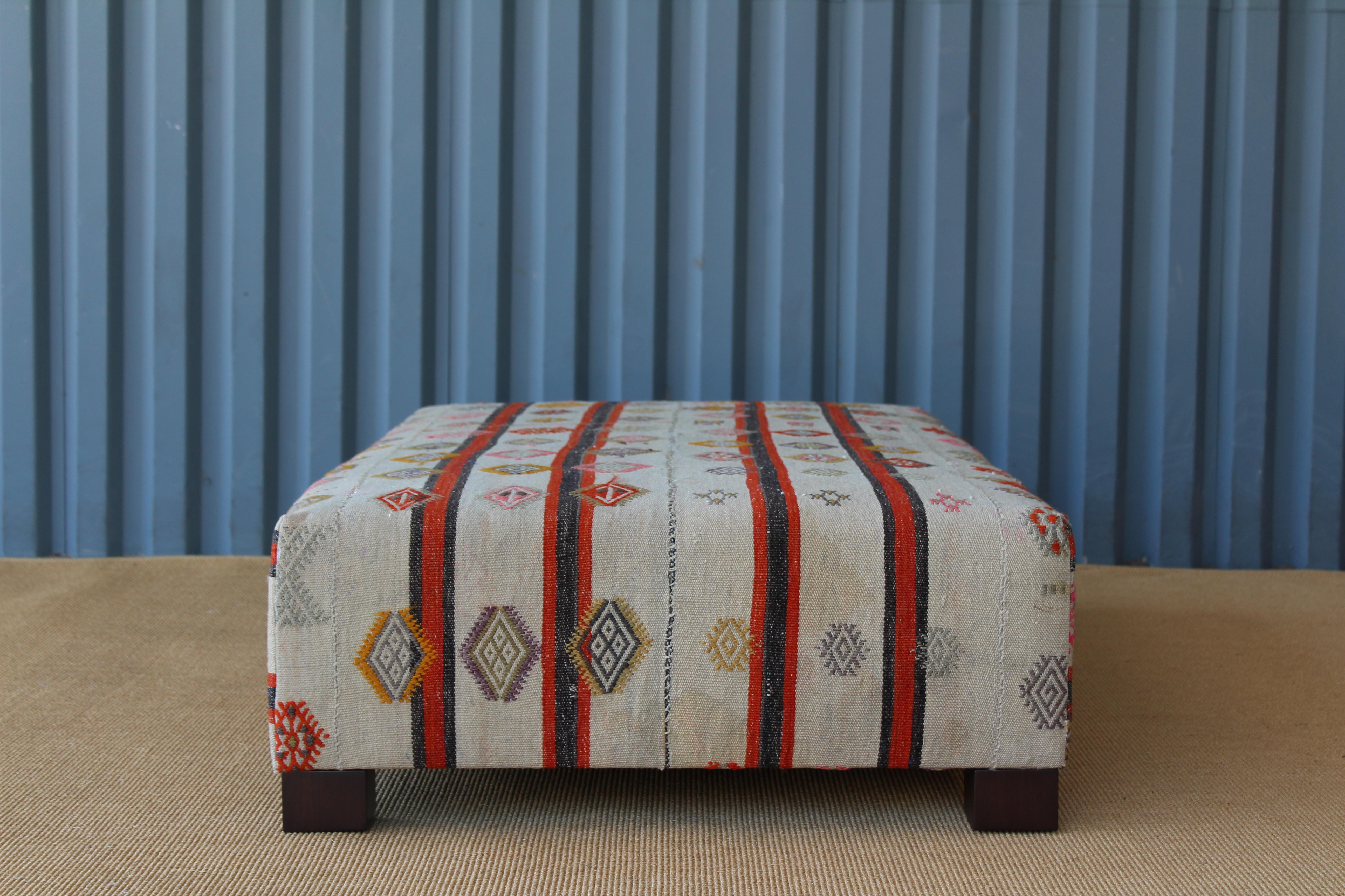 Unknown Ottoman Upholstered in a Vintage Rug