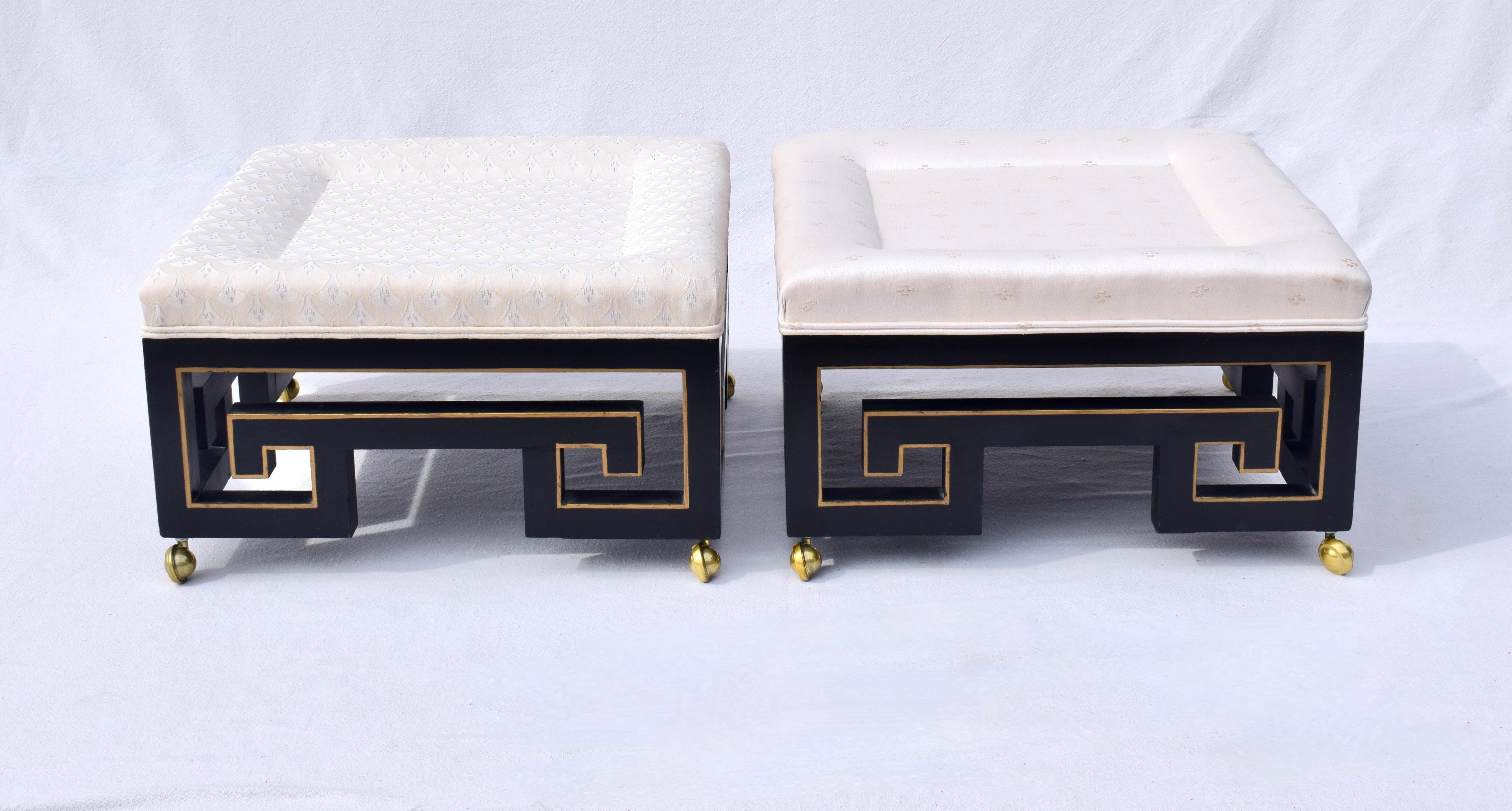 Hollywood Regency pair of ottoman stools with black lacquered Greek key bases and gold accents on brass casters. Marvelous larger scale & quality after James Mont, Dorothy Draper, Barbara Barry, Billy Haines, Billy Baldwin, Tommi Parzinger. 