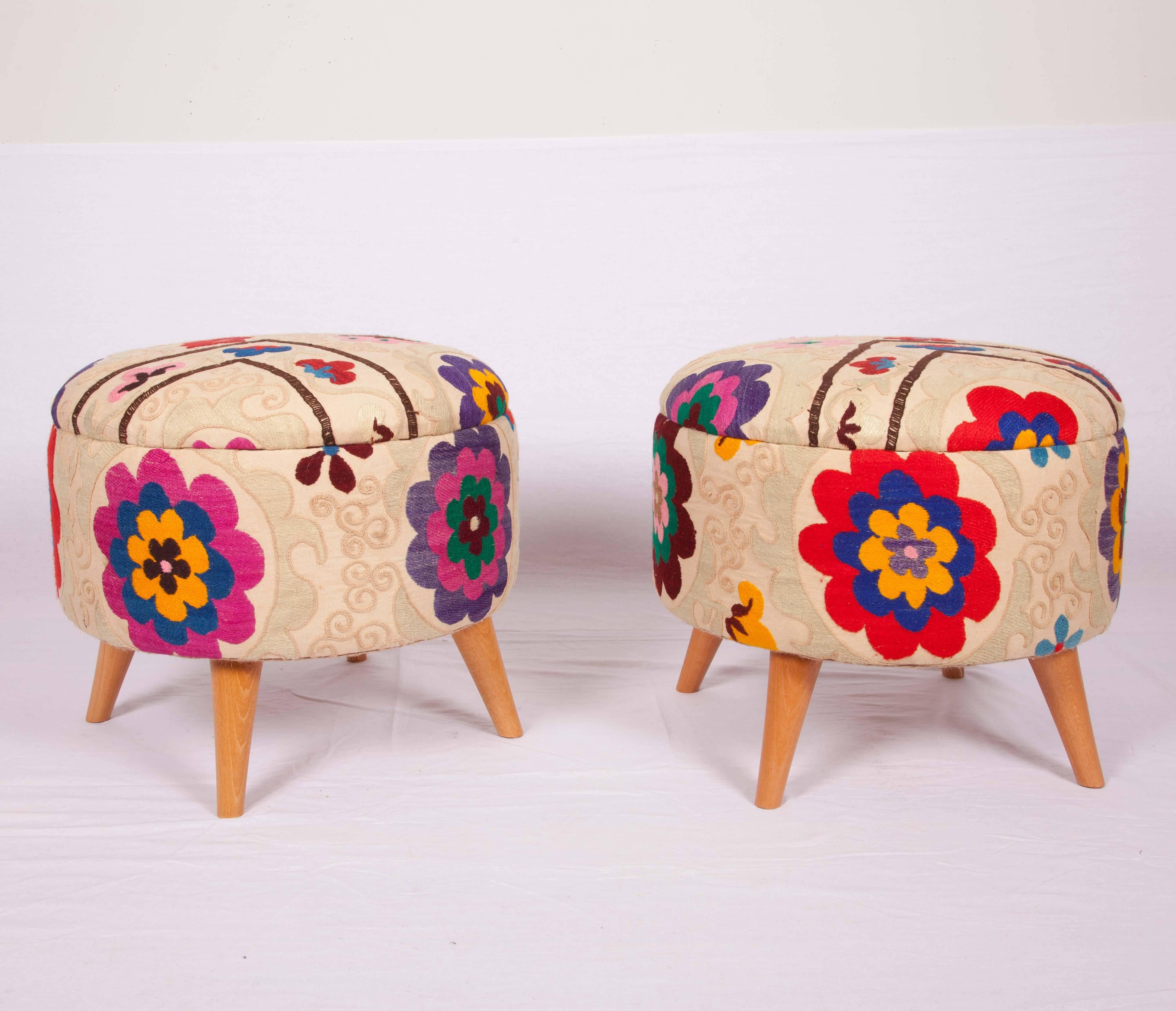 Ottomans or poufs upholstered with a wild looking vintage suzani from Uzbekistan.