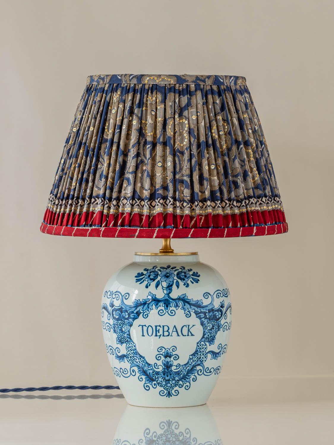 Exquisitely handcrafted by Amitābha Studio in Amsterdam, Toeback is a one-of-a-kind table lamp made from a rare Oud Delft tobacco jar, reflecting the legacy of this celebrated Dutch ceramics brand. Established in 1920 by W.A. van der Want in