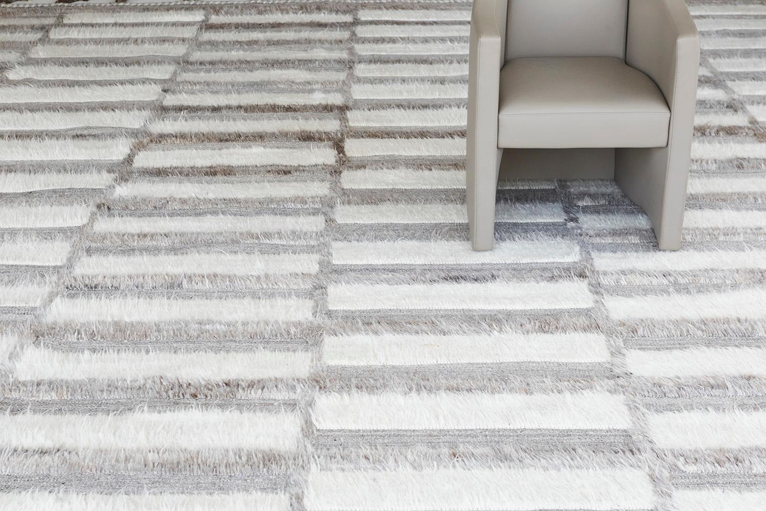 Oudu' is a color-blocking hand-knotted rug that brings movement and dimension to a space. The design is created with embossed detailing through the low shag pile. Inspired by Scandinavian design elements and designed in Los Angeles with extreme