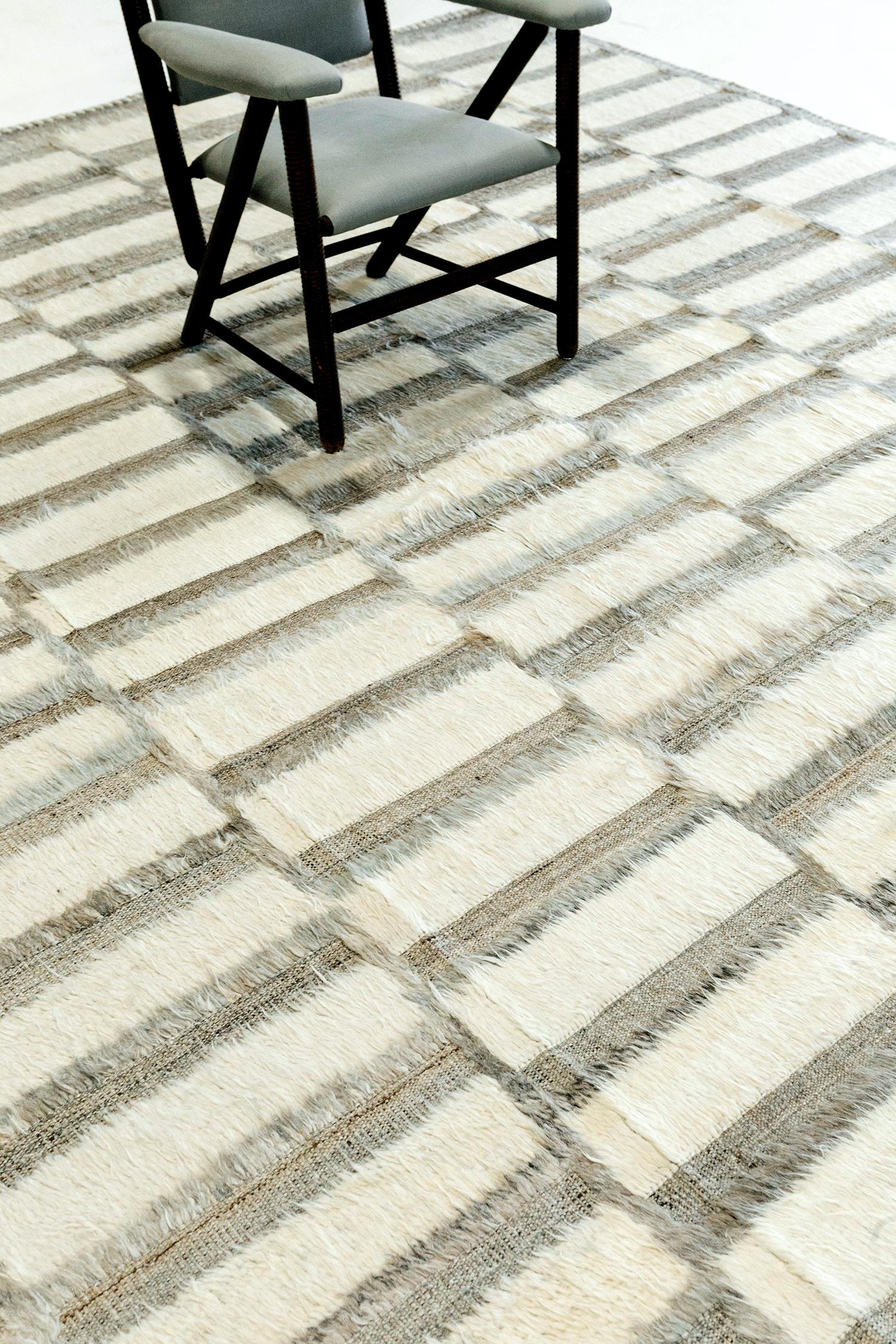 Oudu ist ein handgeknüpfter Farbblockteppich, der Bewegung und Dimension in den Raum bringt. Das Design ist mit geprägten Details durch den niedrigen Zottelflor gestaltet. Inspiriert von skandinavischen Designelementen und mit viel Liebe zum Detail