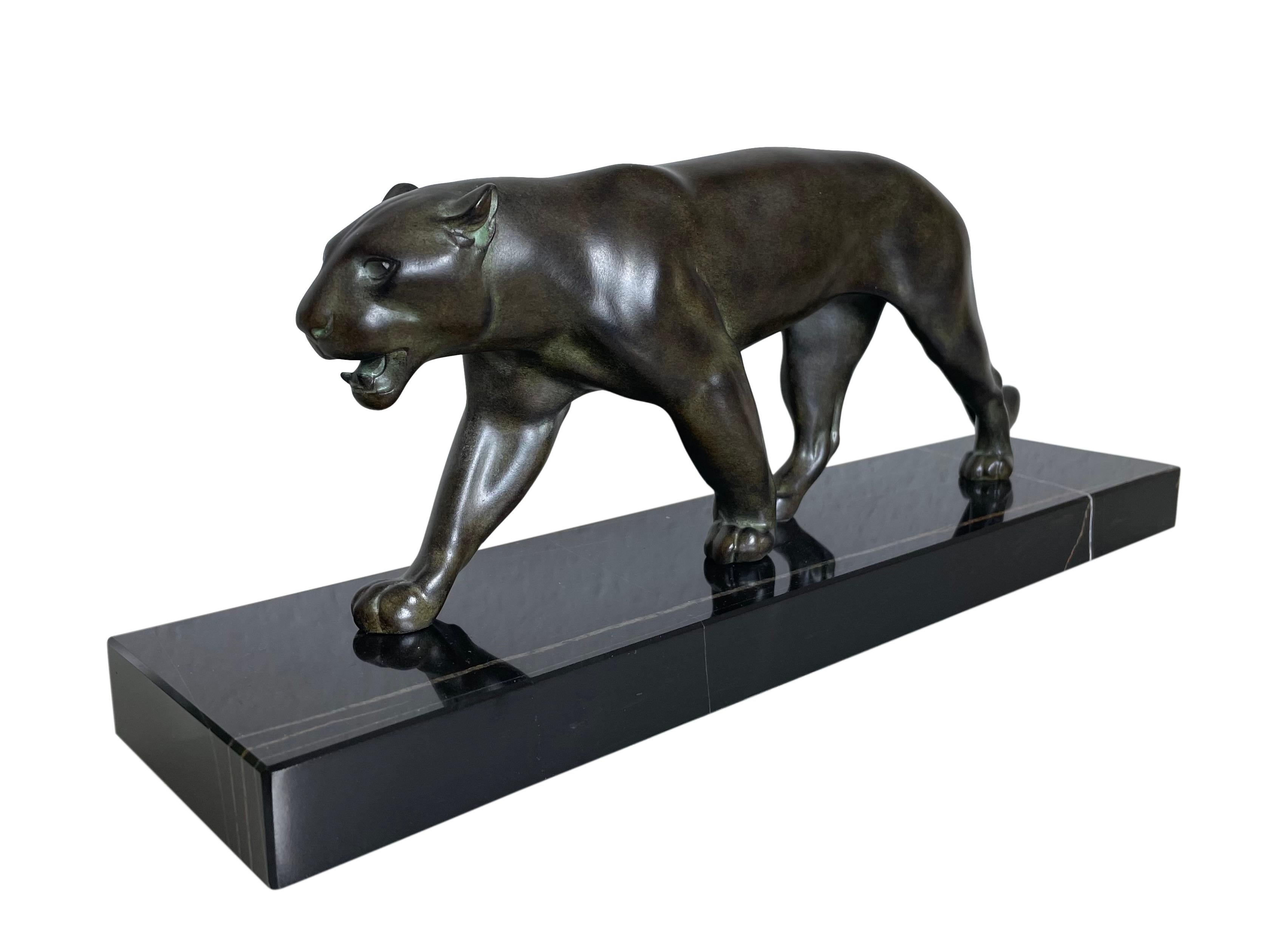 Lion or panther sculpture named “Ouganda”
Original “Max Le Verrier”, signed
Art Deco style, France 

Materials: patinated spelter (French: régule), marble base
Socle could have a different marbleization than the picture
Green patina, handwork