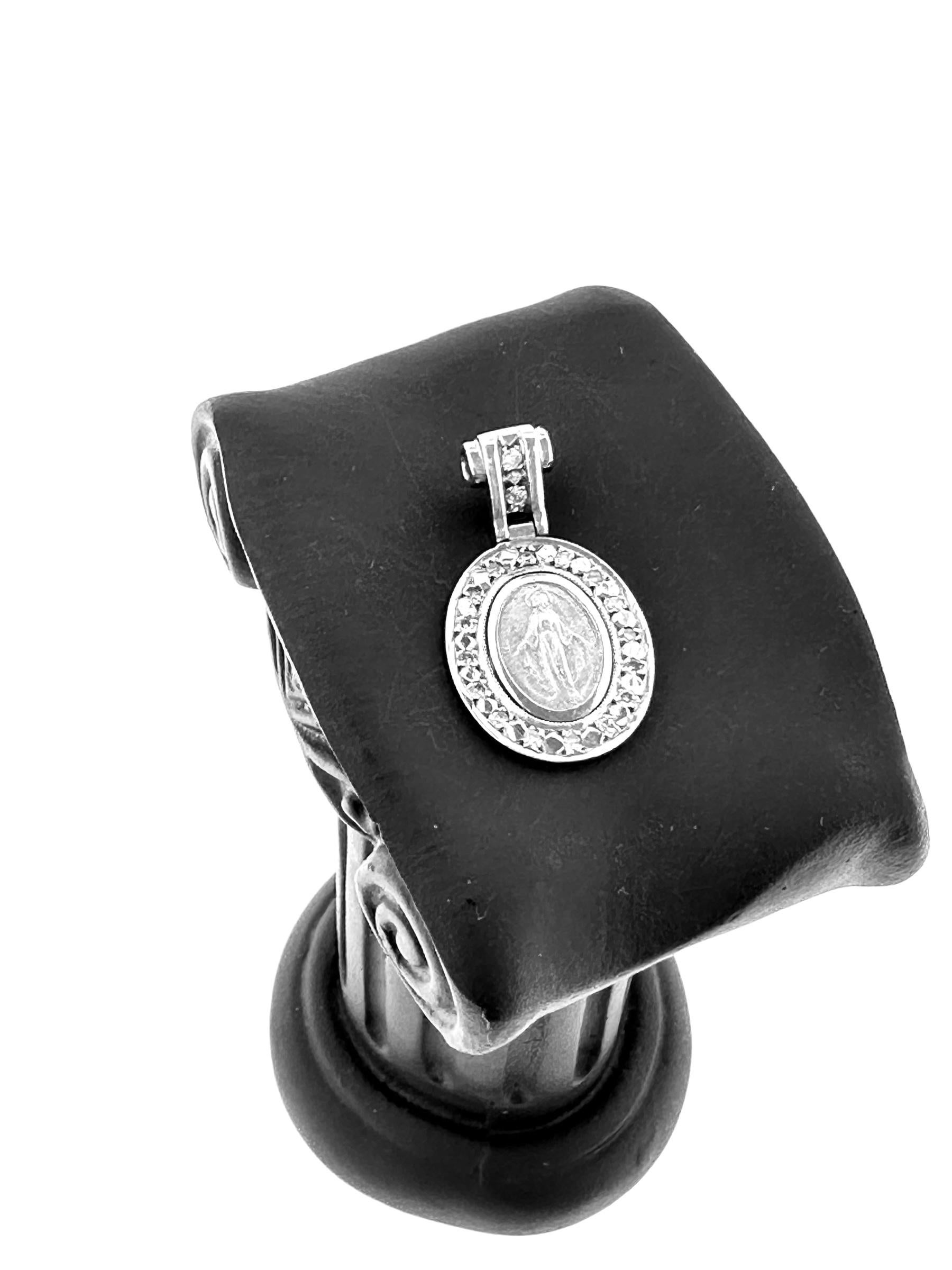The Our Lady of Graces Medal Pendant in White Gold with Diamonds is a divine piece of jewelry that radiates elegance and reverence. Crafted from luminous 18kt white gold, this pendant features a delicate depiction of Our Lady of Graces, a cherished