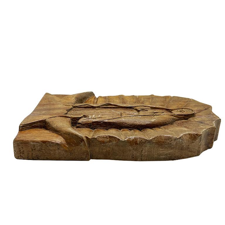A hand-carved Virgin of Guadalupe Wood Plaque. This beautifully crafted wooden hanging plaque features the iconic image of the Virgin of Guadalupe. Carved with intricate detail, it captures her serene expression, flowing robe, and radiant aura. The