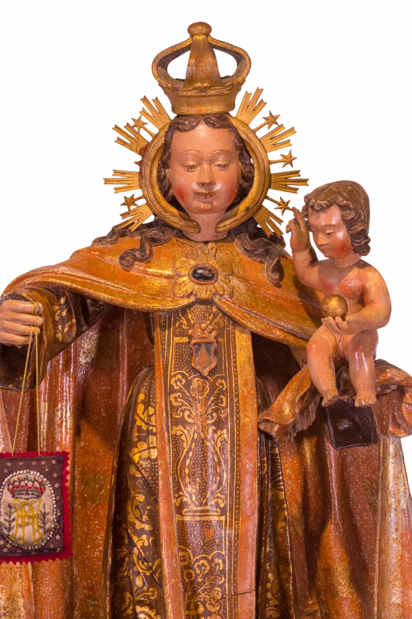 16th Century Spanish gold gilded and polychromed Carved-wood sculpture of Our Lady of Mount Carmel. She depicts the Blessed Virgin Mary in her role as patroness of the Carmelite Order. She was above the main altar for approximately 500 years. The