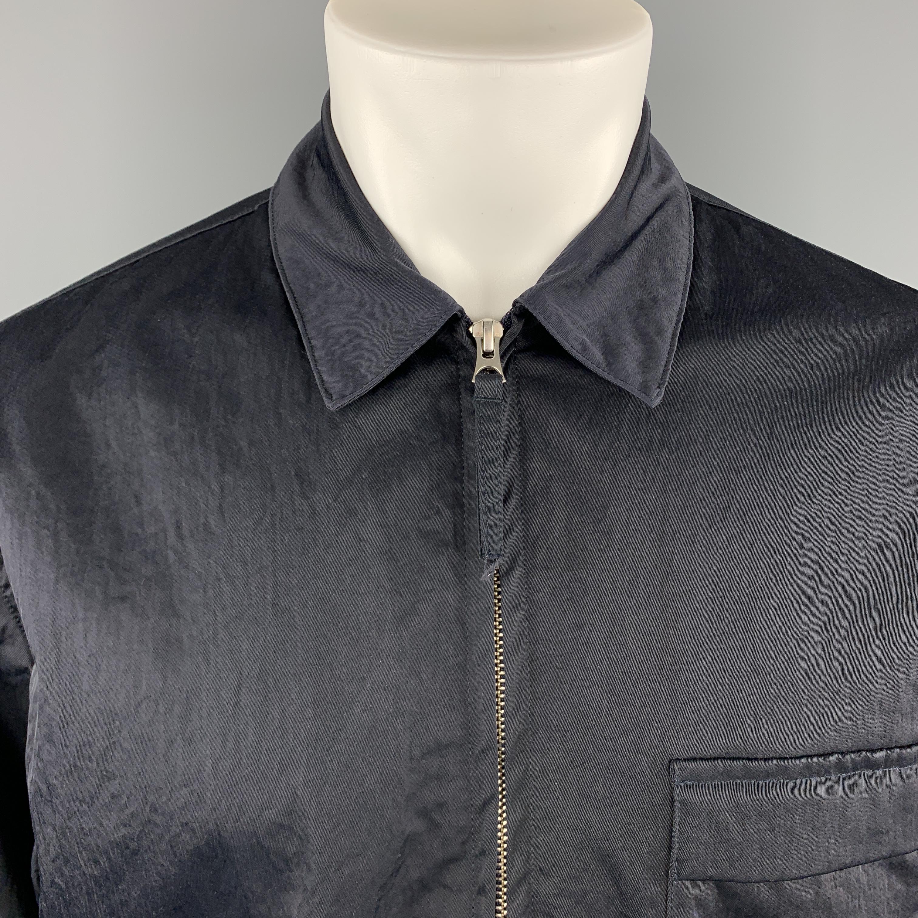OUR LEGACY jacket comes in navy textured nylon wih a pointed collar, zip front, and flap pocket. Made in Portugal.

Excellent Pre-Owned Condition.
Marked: IT 48

Measurements:

Shoulder: 18 in.
Chest: 45 in.
Sleeve: 25.5 in.
Length: 29 in.