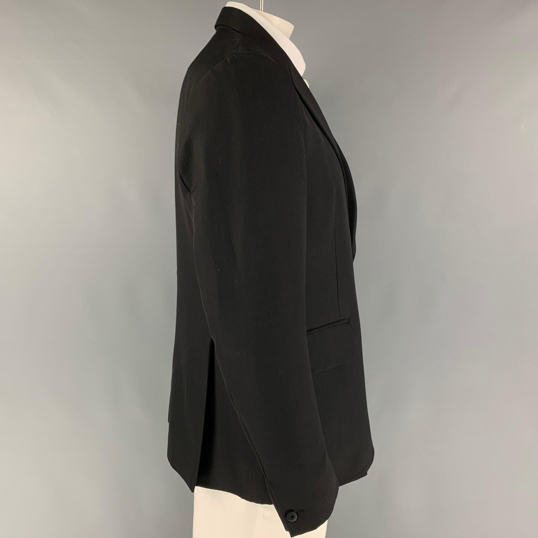 OUR LEGACY sport coat comes in a black virgin wool with a full liner featuring a notch lapel, flap pockets, double back vent, and a double button closure. Made in Portugal.
Very Good
Pre-Owned Condition. 

Marked:   54 

Measurements: 
 
Shoulder: