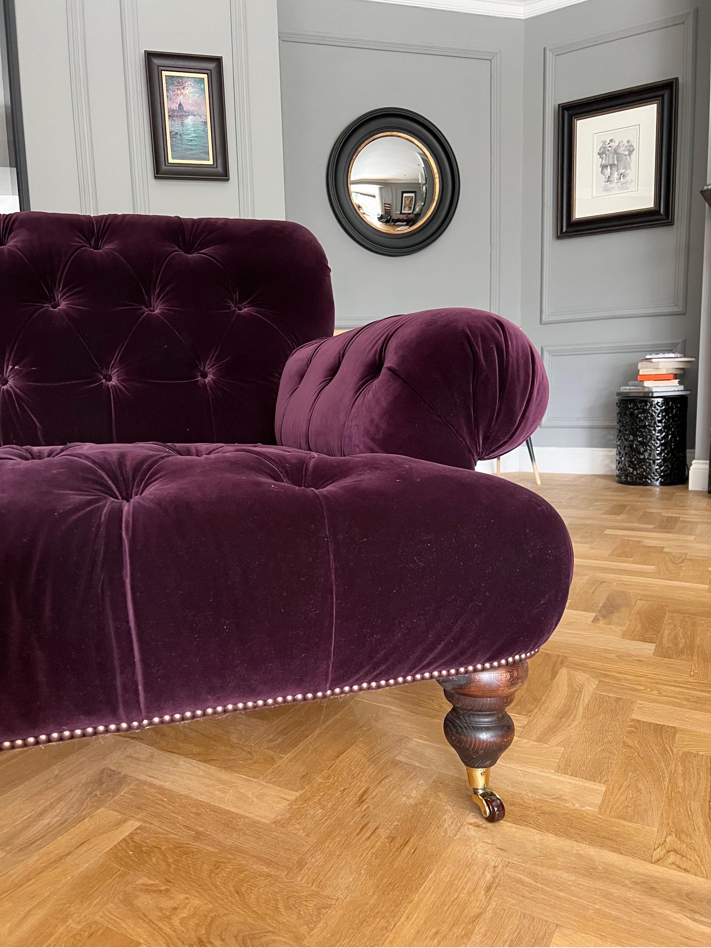 purple tufted sofa