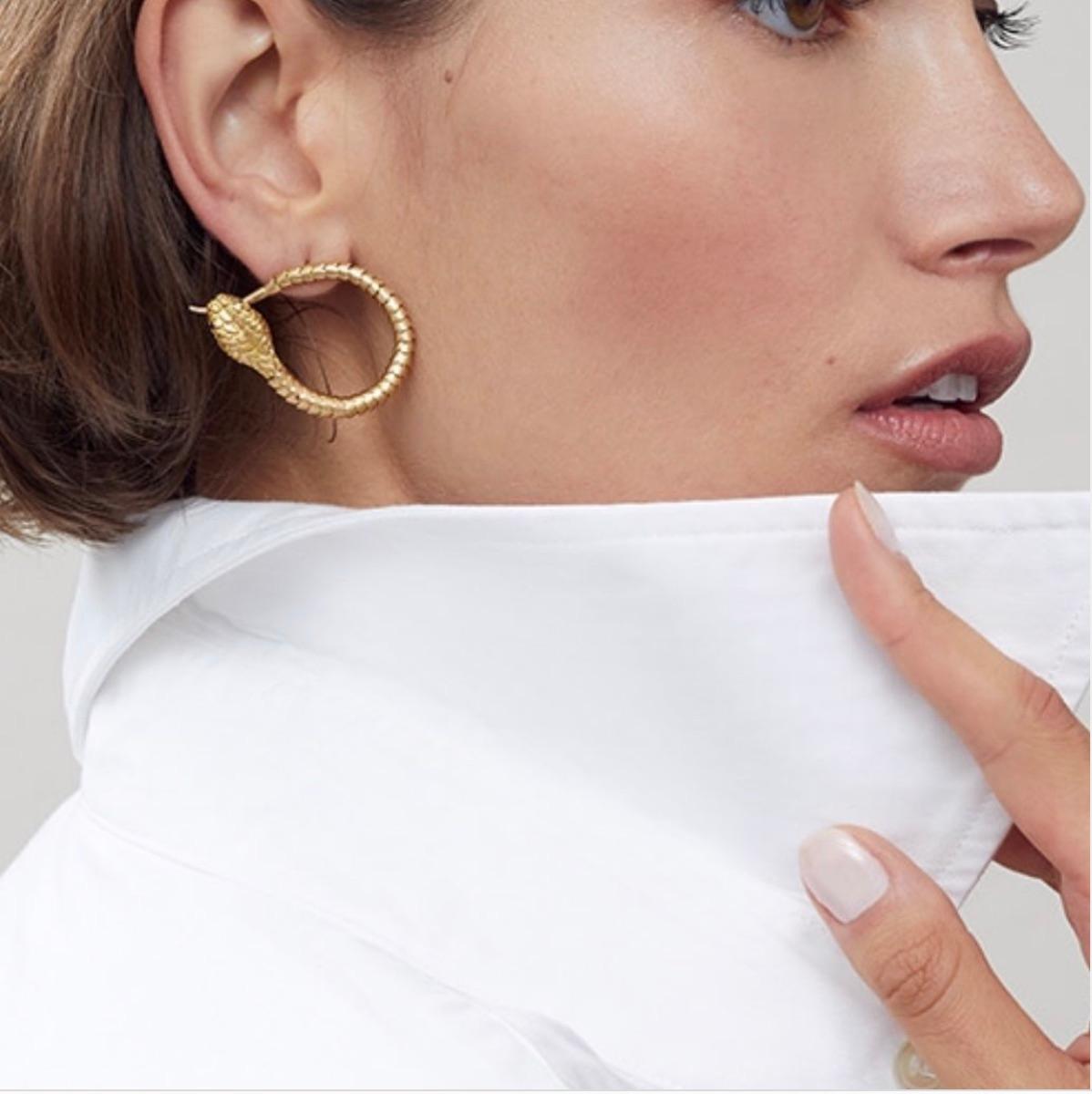 These 18K gold hand articulated snakes earrings are meticulously hand made - each individual ring/scale is made by hand and then pinned from the inside so that the movement is as silky as a real snake.  The jaw then opens to reveal two fangs,  which