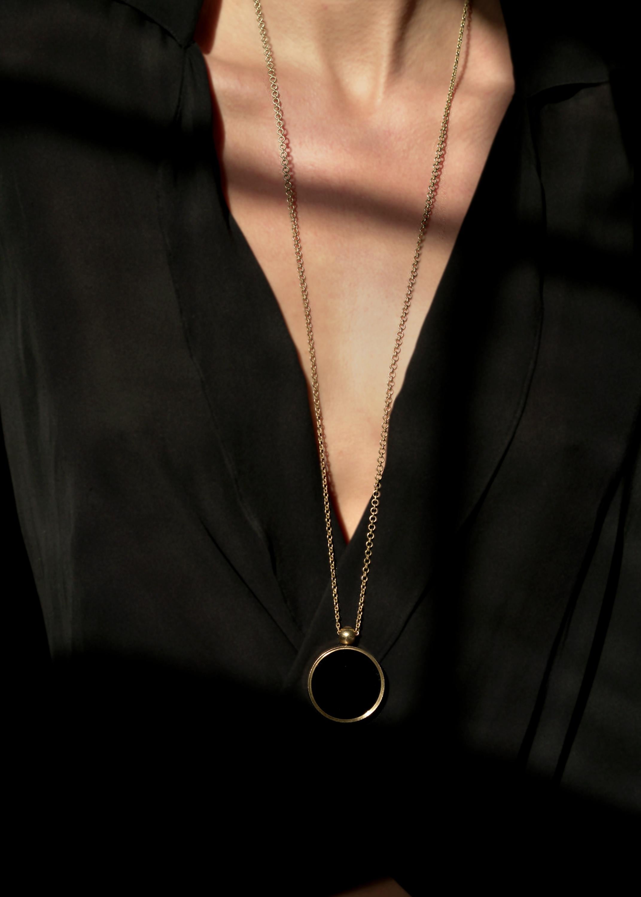 Modern Ouroboros' 18kt Gold Black Shell and Mother of Pearl Pendant For Sale