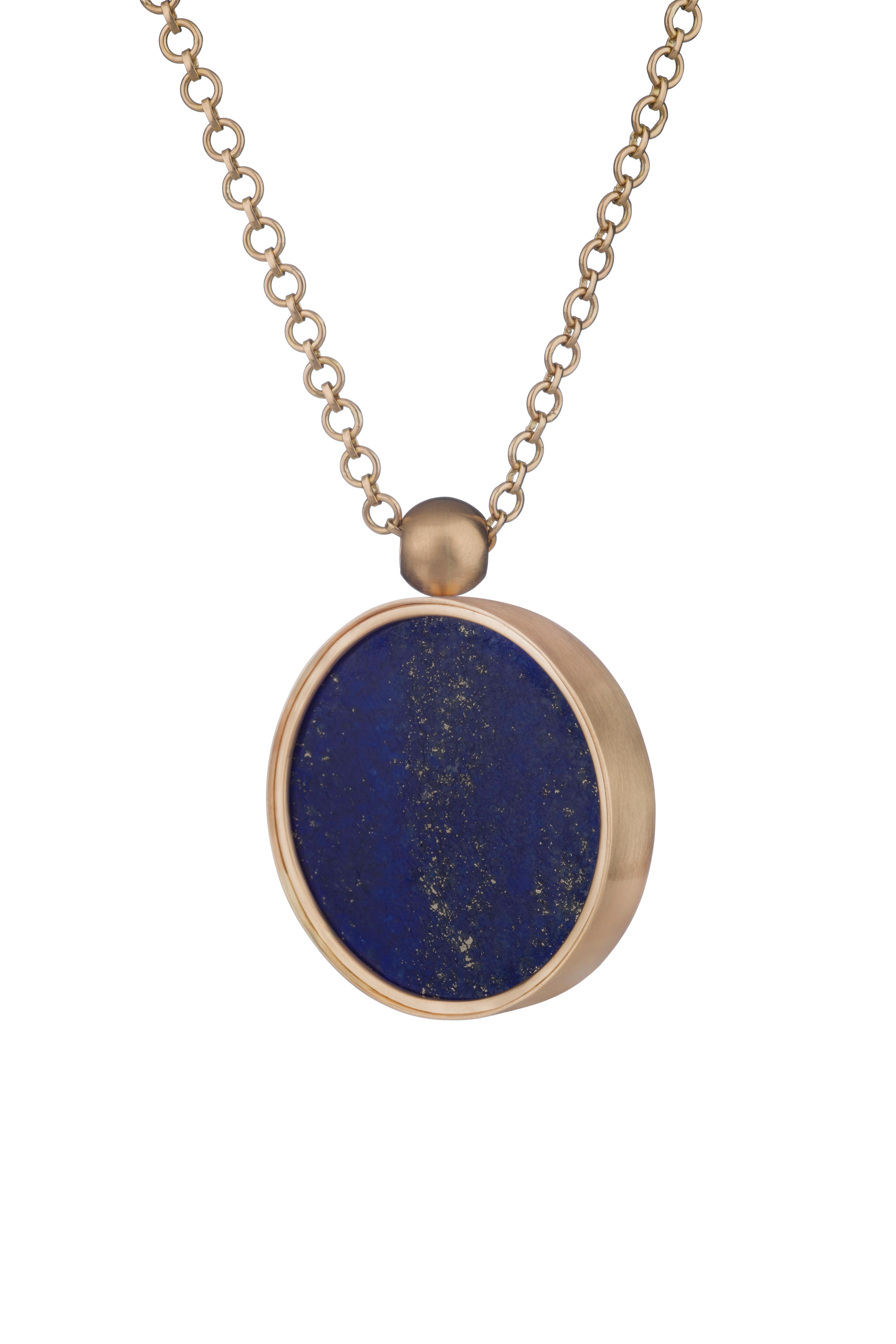 WHISTLER'S MILKY WAY SUN

Ouroboros lapis lazuli sun swivel pendant set in 18 karat gold on a handmade 18 karat gold chain, with an 18 karat gold Ouroboros lasered ball to finish the back. There is a black rhodium plated silver chain option. 

This