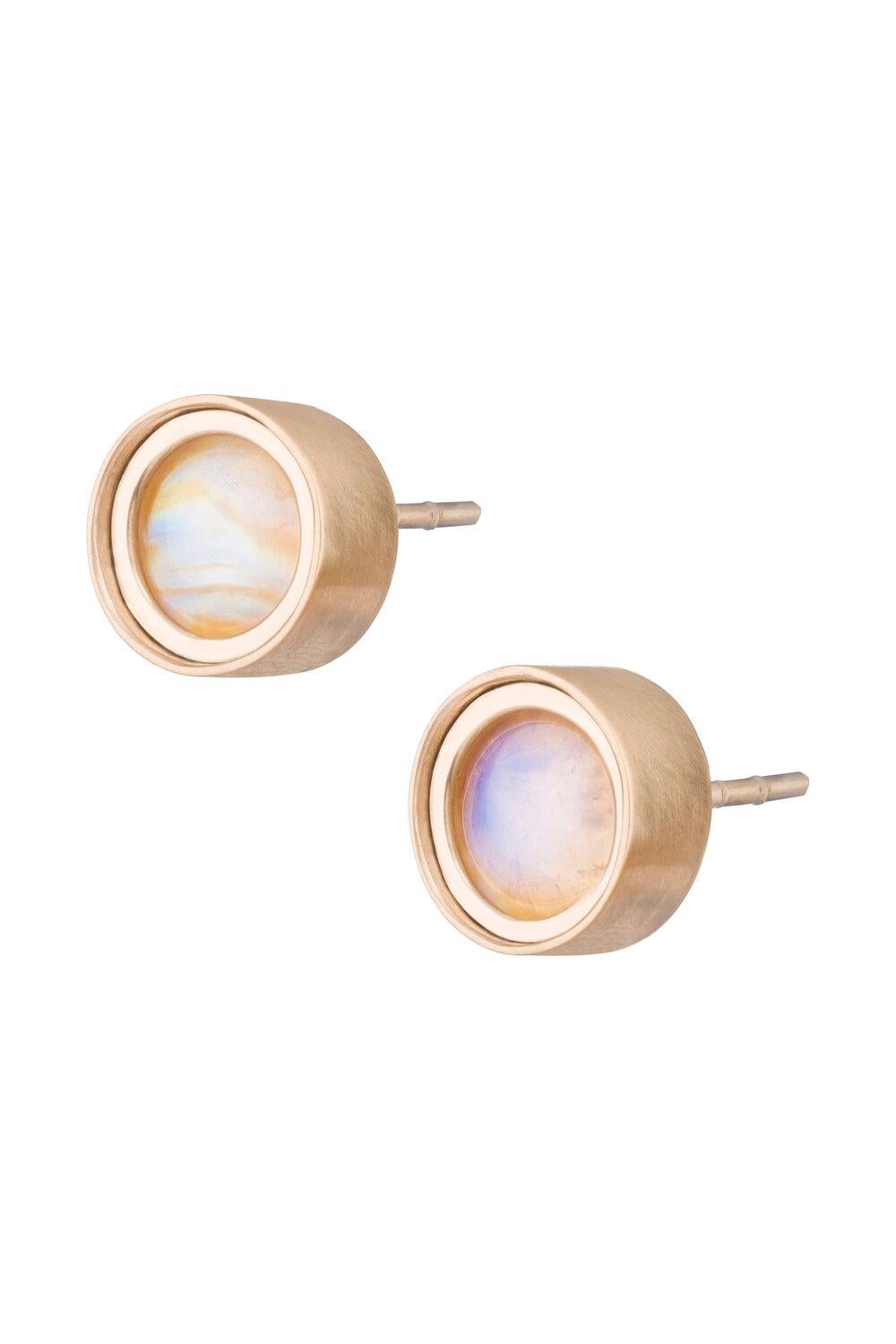 OUROBOROS rainbow moonstone round cabochon studs in a ridged frame of 18kt gold studs. Blue and white rainbow moonstone options.

OUROBOROS’ commitment to using only the most unique stones set in 18 or 24 Karat gold, is matched only to Olivia’s