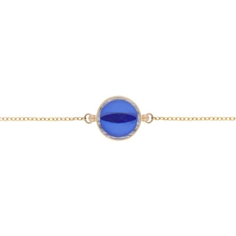 Ouroboros rainbow moonstone and lapis lazuli inlaid snake eye handmade bracelet set in 18 karat gold. 

This piece is made completely by hand and if it is out of stock takes 4 to 6 weeks to produce. 

OUROBOROS is an artisanal brand, based out of