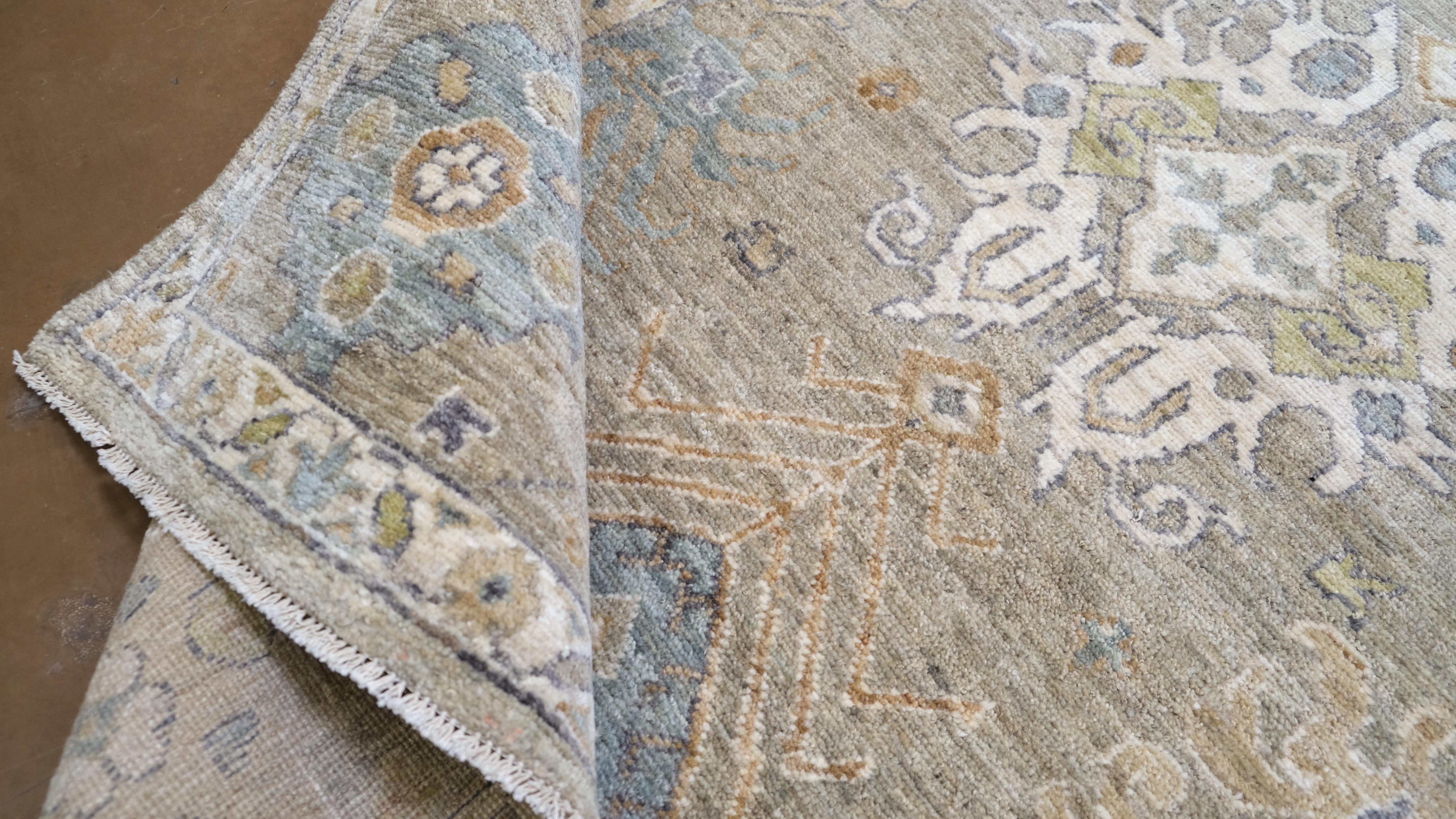 Verschönern Sie Ihren Raum mit der zeitlosen Schönheit dieses handgeknüpften Wollteppichs. Mit einem komplizierten floralen  Das von einer klassischen Bordüre umrahmte Design dieses Teppichs zeigt eine harmonische Farbpalette aus sanftem Blau, Weiß